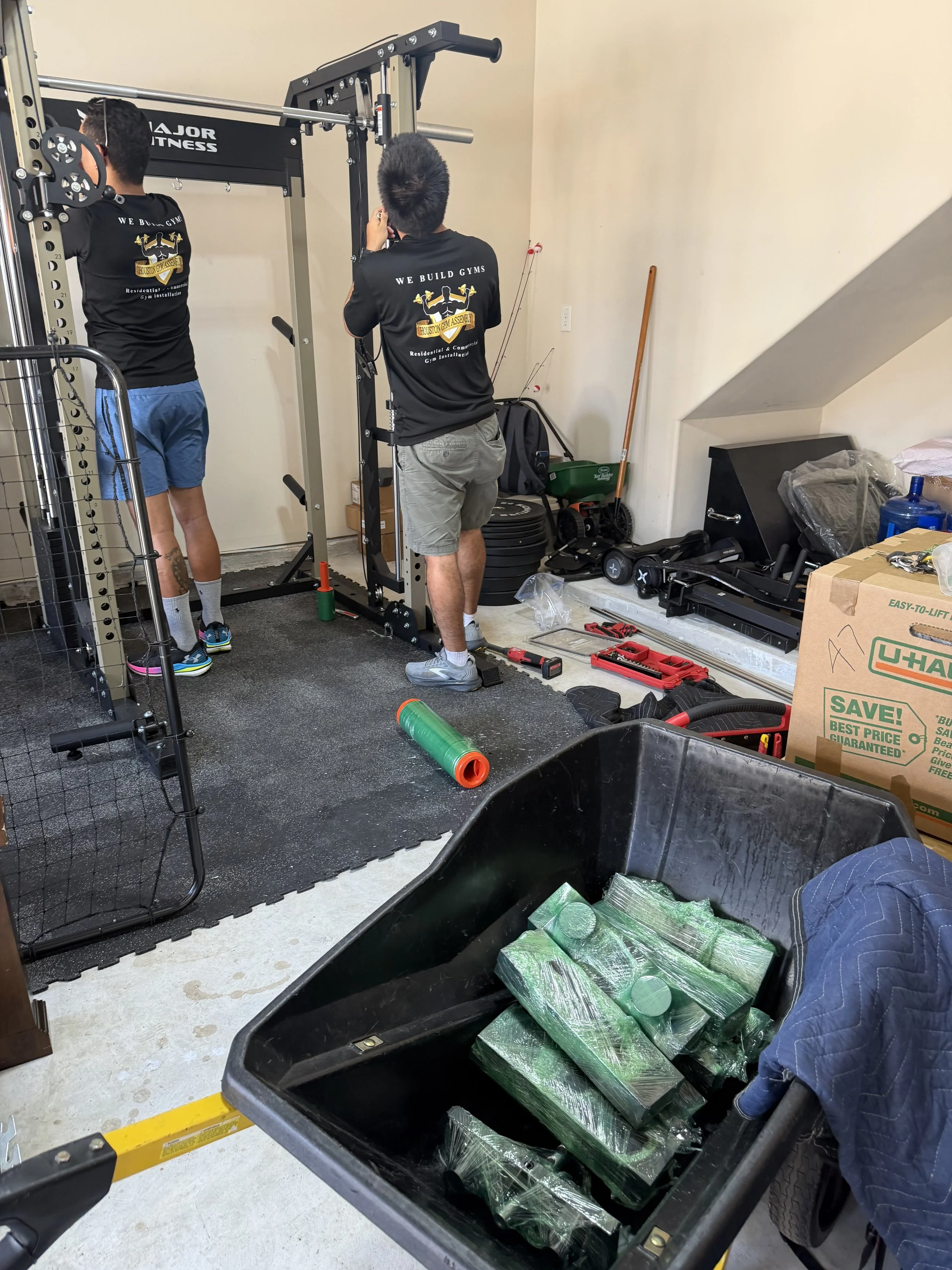 Houston Gym Assembly technicians preparing a Smith Machine before relocation