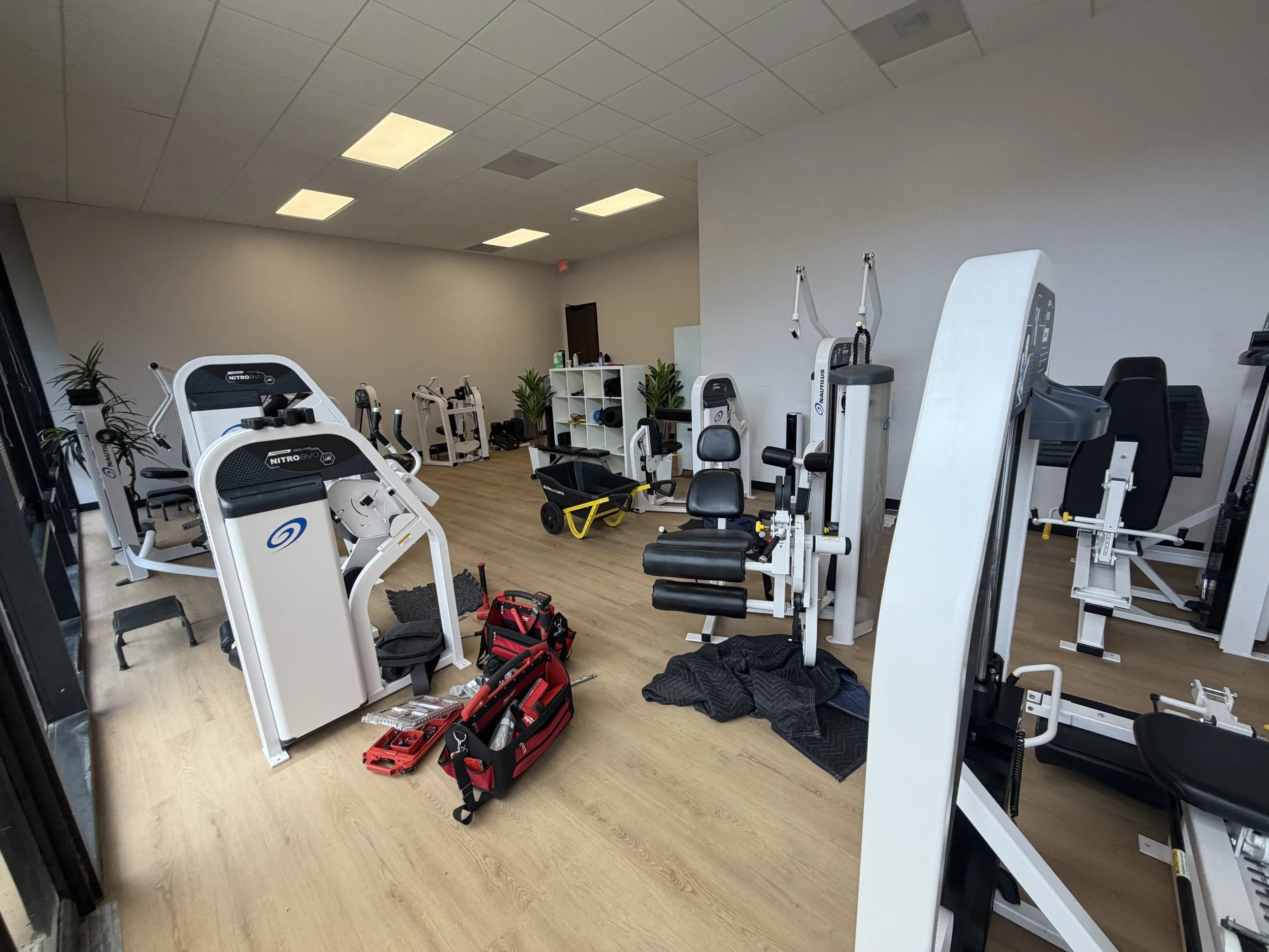 Commercial gym equipment being reassembled by Houston Gym Assembly after moving from another location.