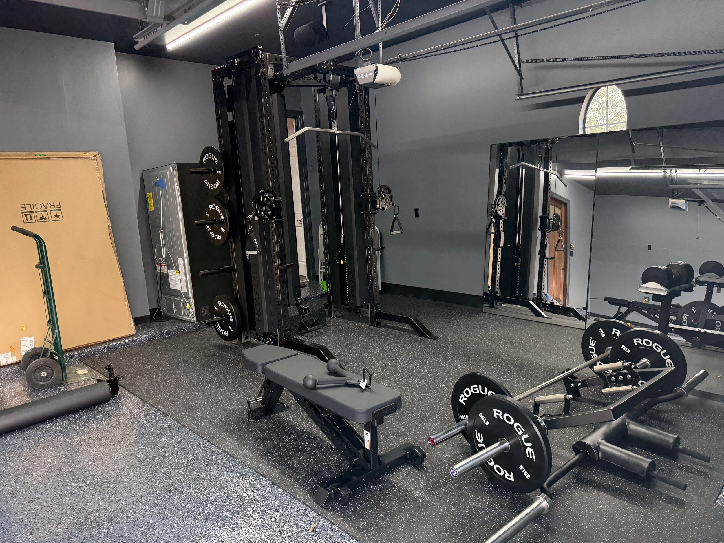 Rogue FM HR Functional trainer with Rogue barbell, plates, and Rogue adjustable bench