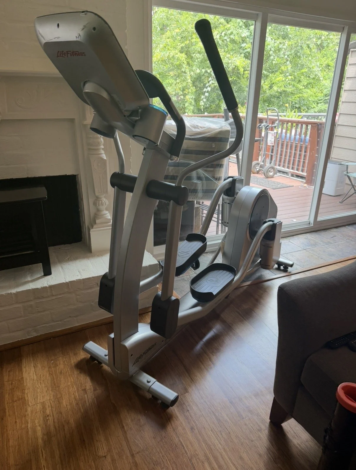 Life Fitness elliptical left on the first floor after a home move before professional fitness equipment relocation upstairs