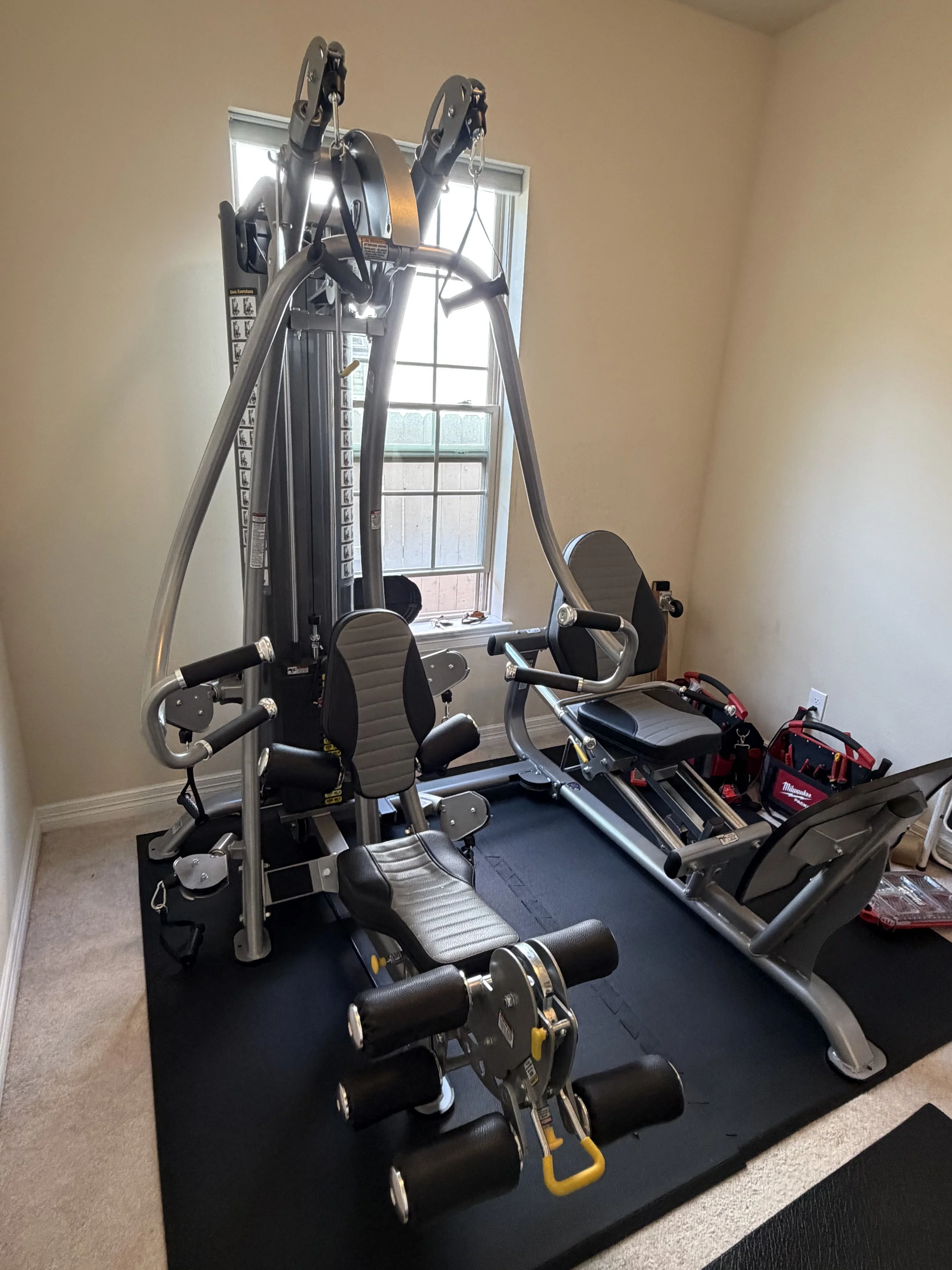 TuffStuff home gym being professionally disassembled and prepared for moving by Houston Gym Assembly.