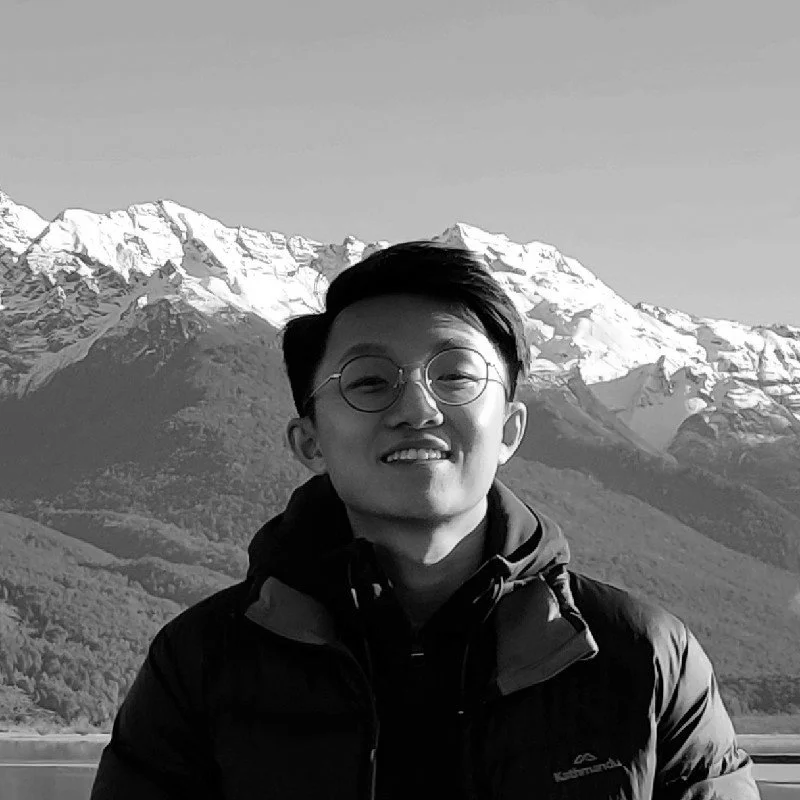 Picture of Kelvin Tan, Head of Growth at Manukora, smiling with a mountain backdrop.