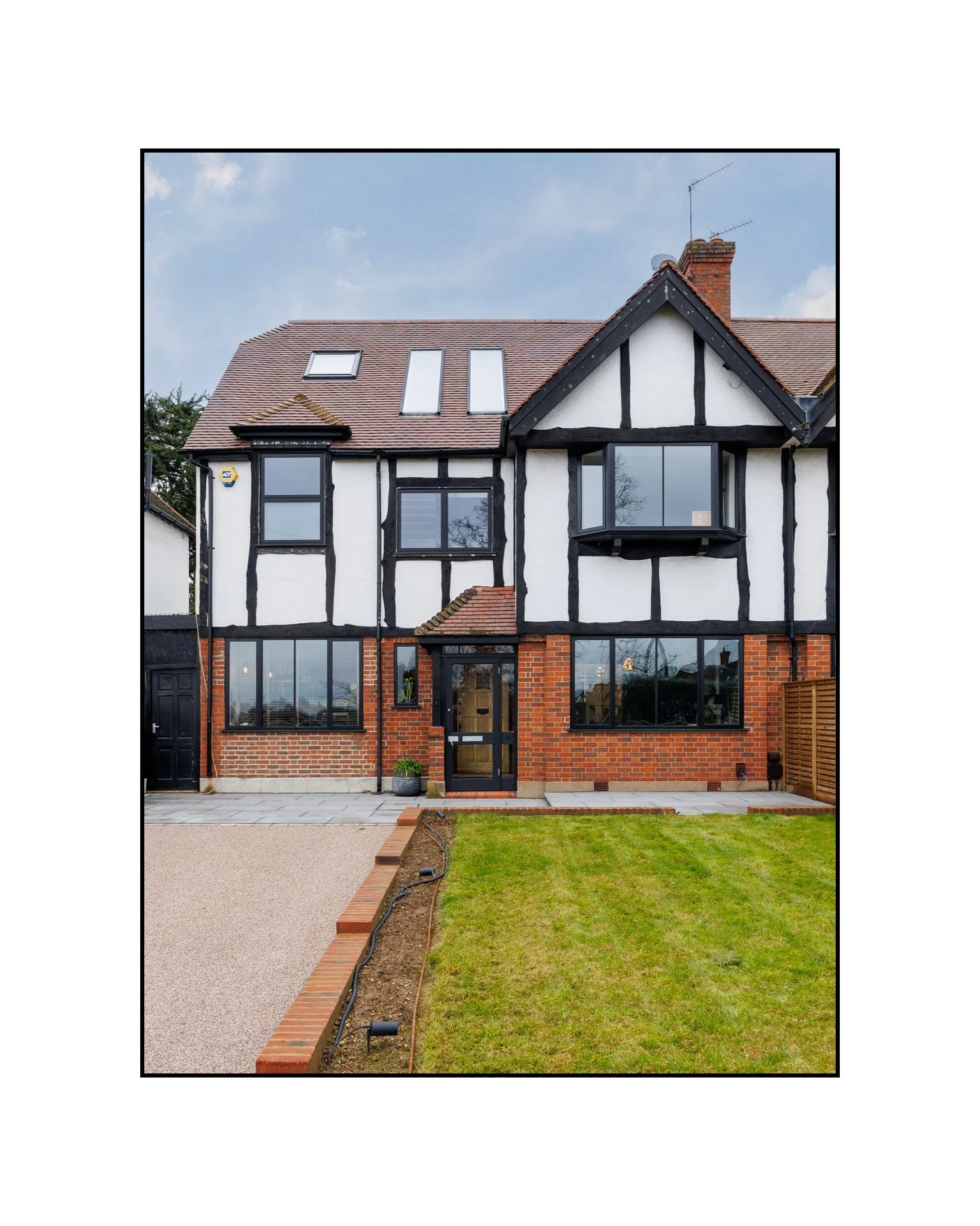 Tudor outside. Completely transformed inside. Swipe to see. &rarr;

---

Slide 1 &mdash; Tudor exterior, red brick, black timber frame, front lawn
The facade tells you it has history. What's inside will surprise you.

Slide 2 &mdash; Inky blue sittin