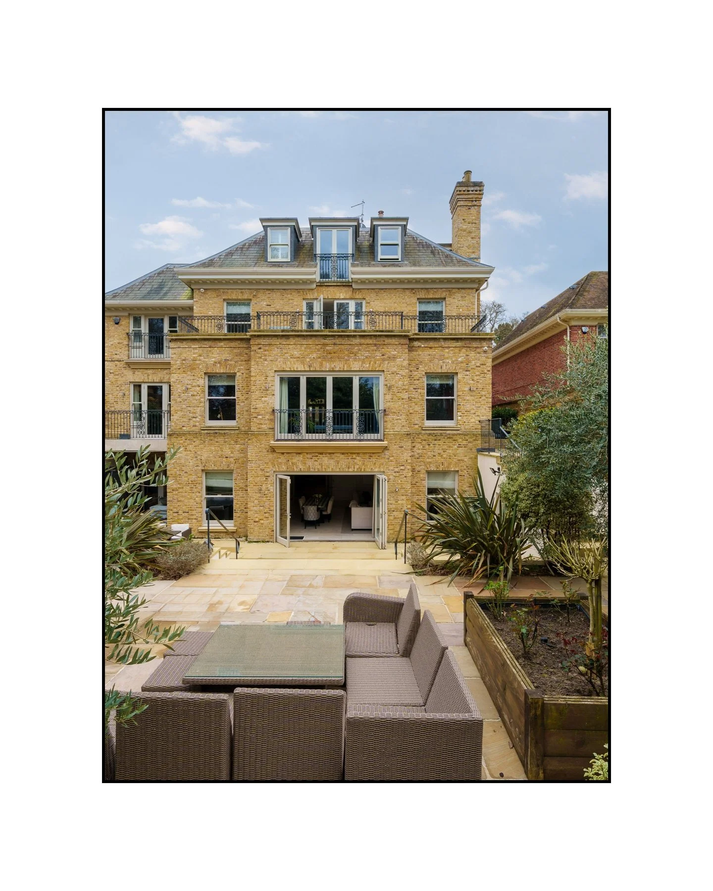 When a Wimbledon address comes with an indoor pool and a steam room. Swipe. &rarr;

---

Slide 1 &mdash; Grand London stock brick rear, terrace, ironwork balconies
London stock brick, wrought iron balconies, and bifold doors straight onto the terrace
