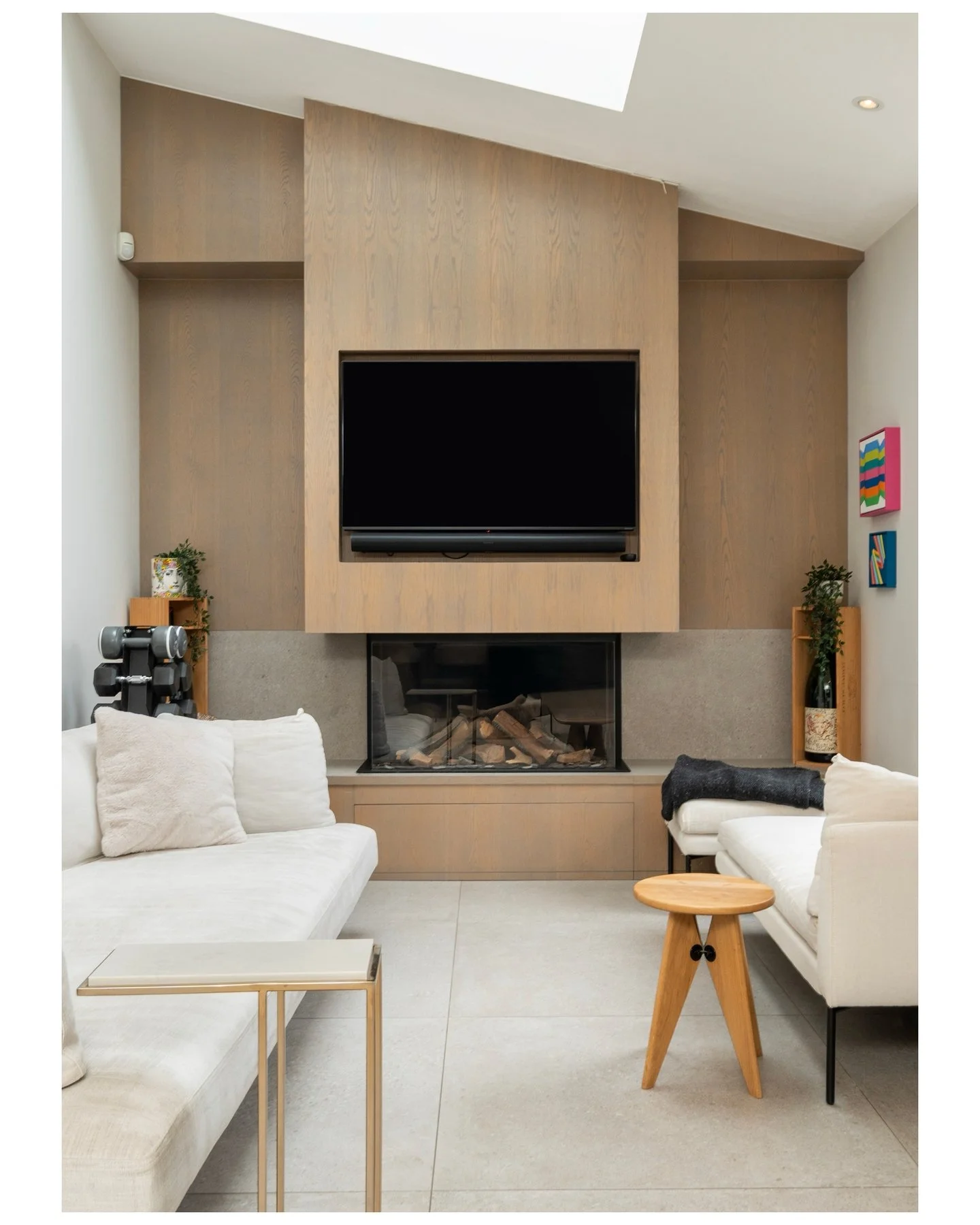 A Tulse Hill townhouse with a wine room behind a crittall door. Keep swiping. &rarr;

---

Slide 1 &mdash; Snug, oak media wall, log fireplace, skylight
An oak-panelled media wall, a log burner, and a rooflight overhead. The snug that never lets you 