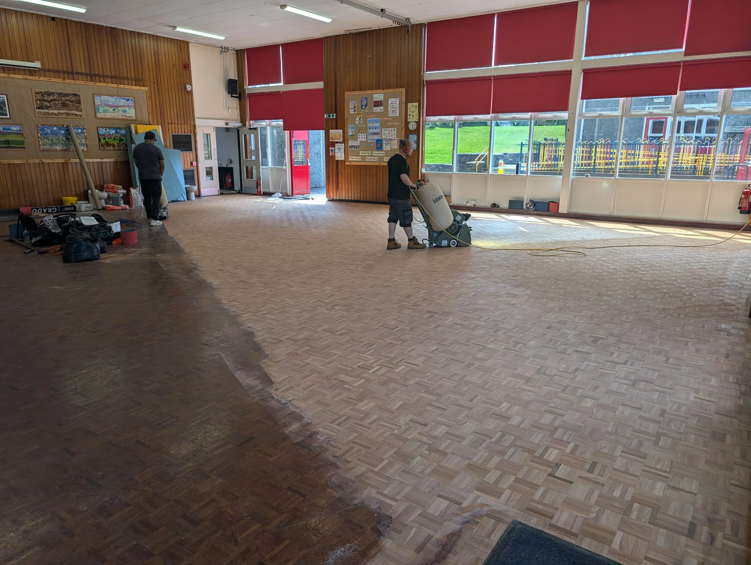 Commercial wood floor during sanding and restoration.