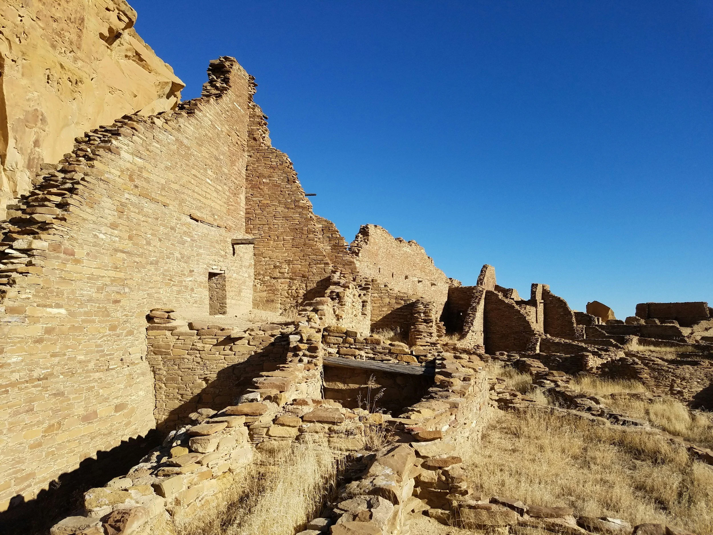 An ancient staircase set against a bright blue sky in Chaco Valley, New Mexico