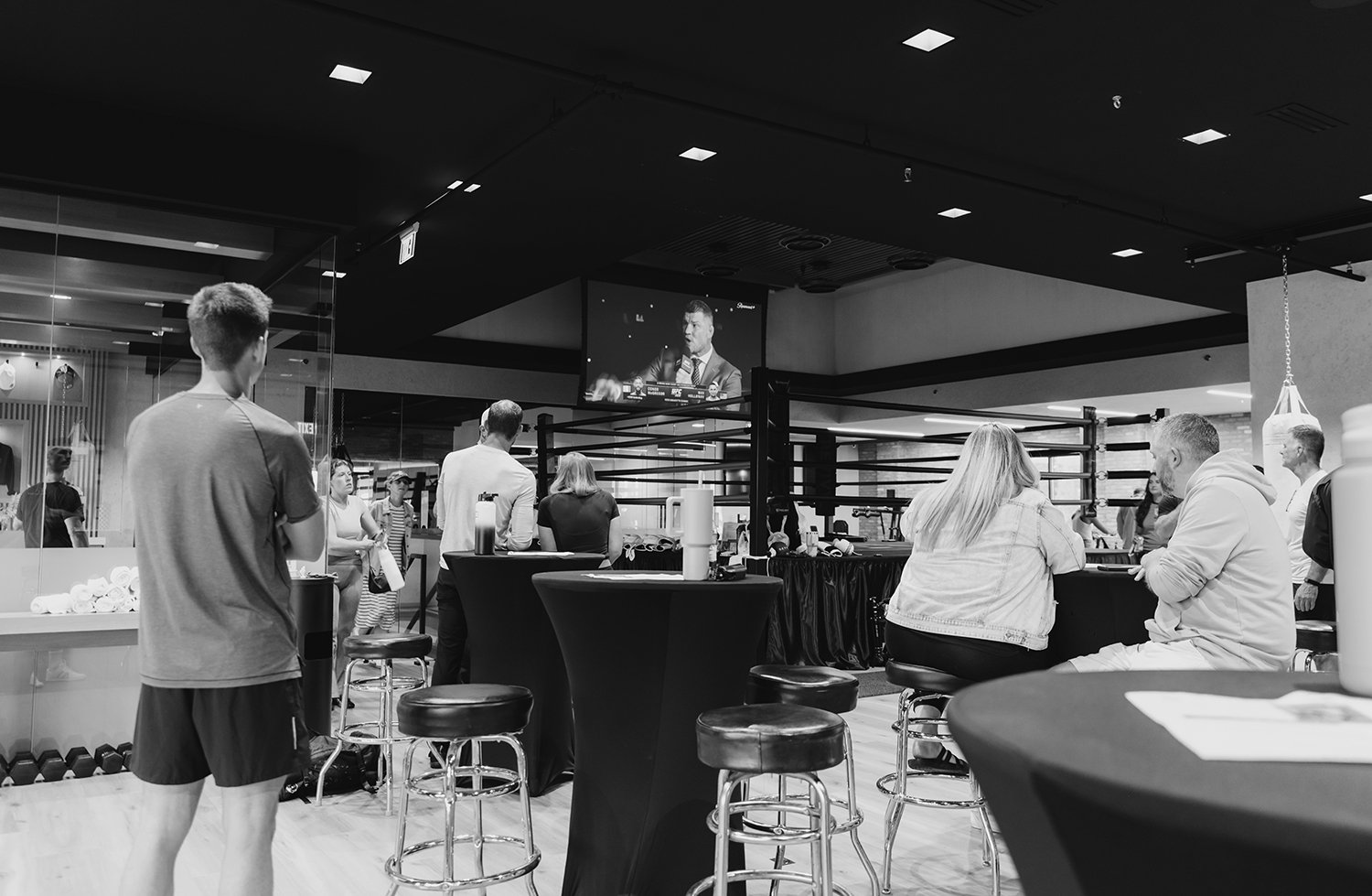 Large open workout space converted to a gathering space with large screen for viewing or presenting.