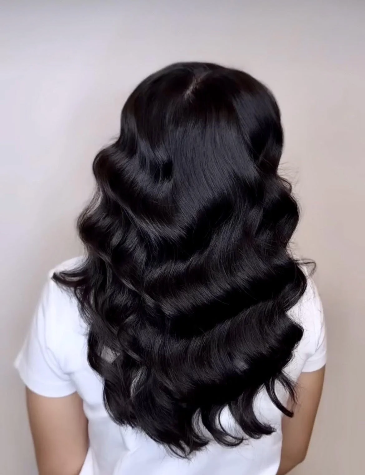 Holiday Hollywood waves hairstyle with glossy curls and deep side part created at Gem House Salon in Greenpoint Brooklyn near Williamsburg and Long Island City.