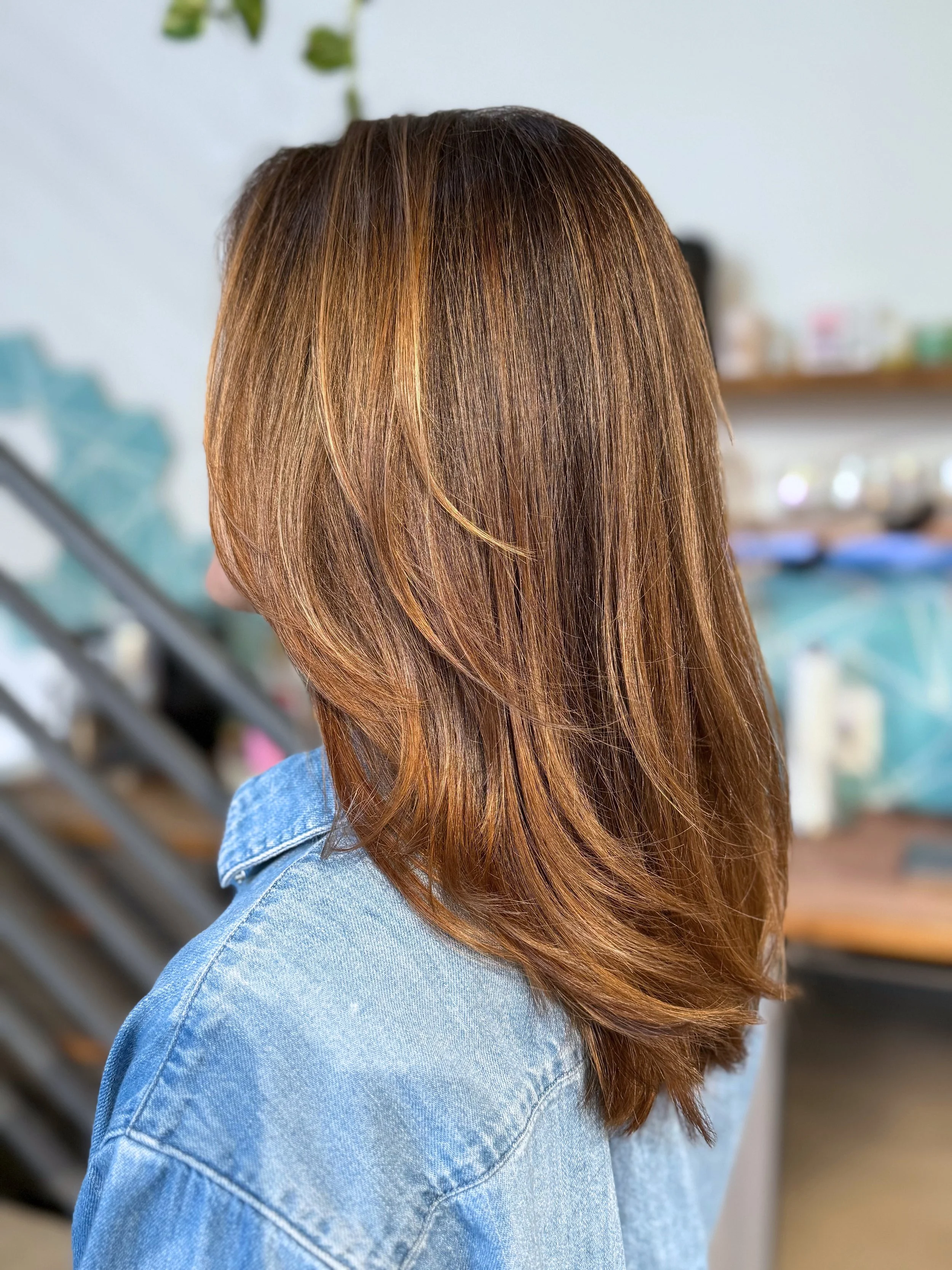 Bronzed balayage hair color with warm honey and amber tones by Gem House Salon in Greenpoint Brooklyn.