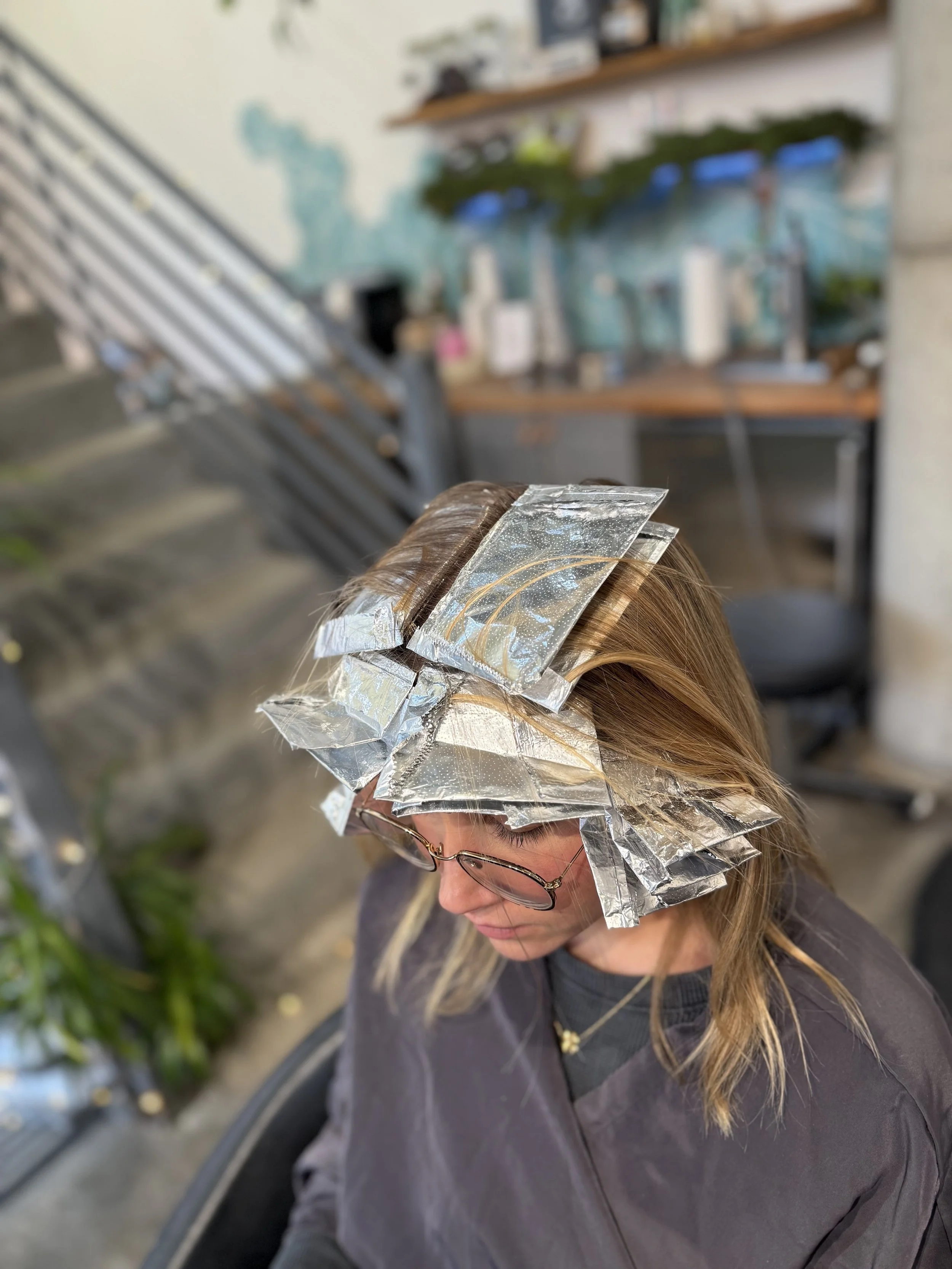 Highlights processing at Gem House Salon in Greenpoint Brooklyn, foils placed for a dimensional blonde color service and expert highlighting