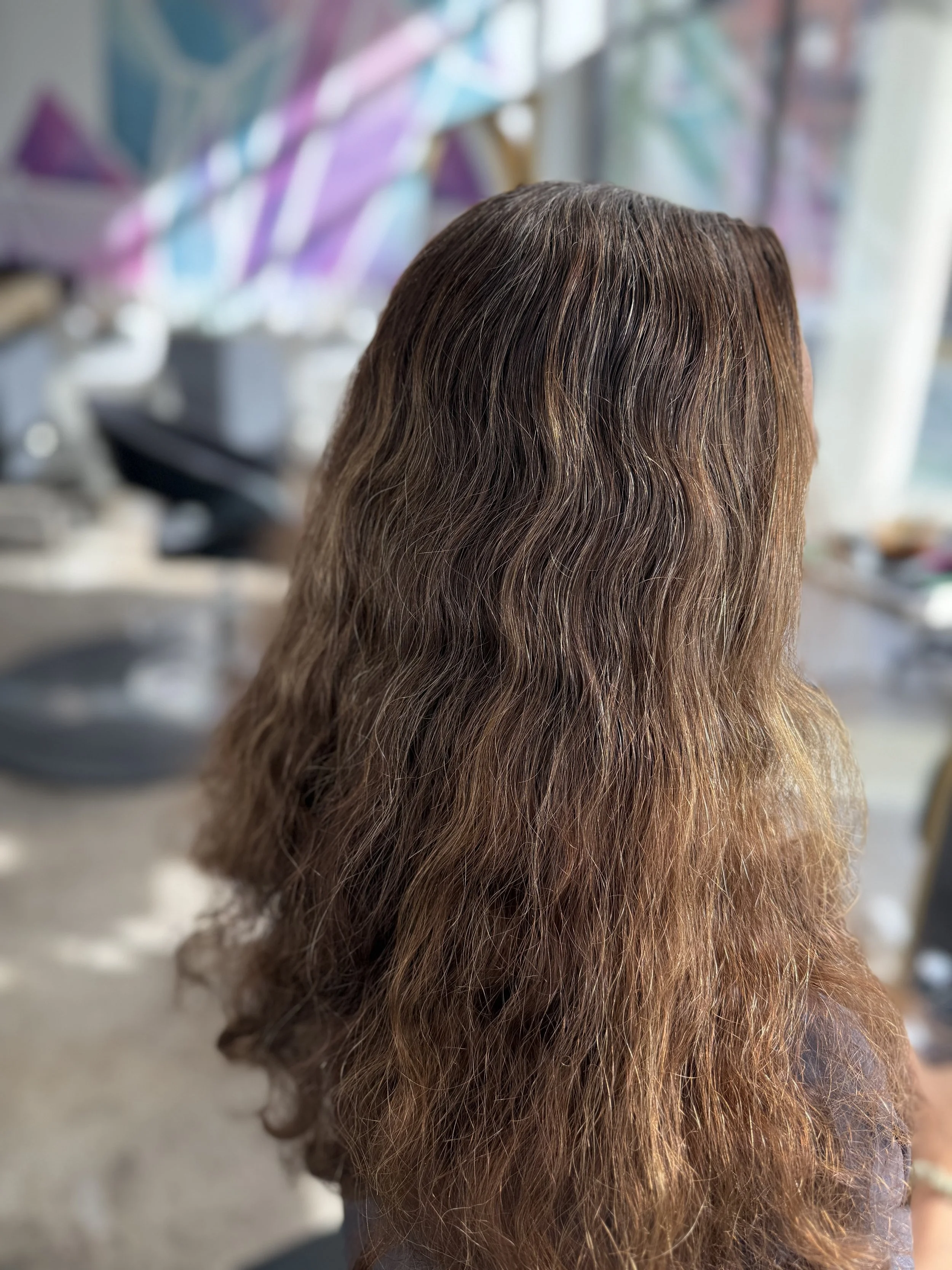 Lived-in grey blending with soft highlights for natural grow out at NYC hair salon