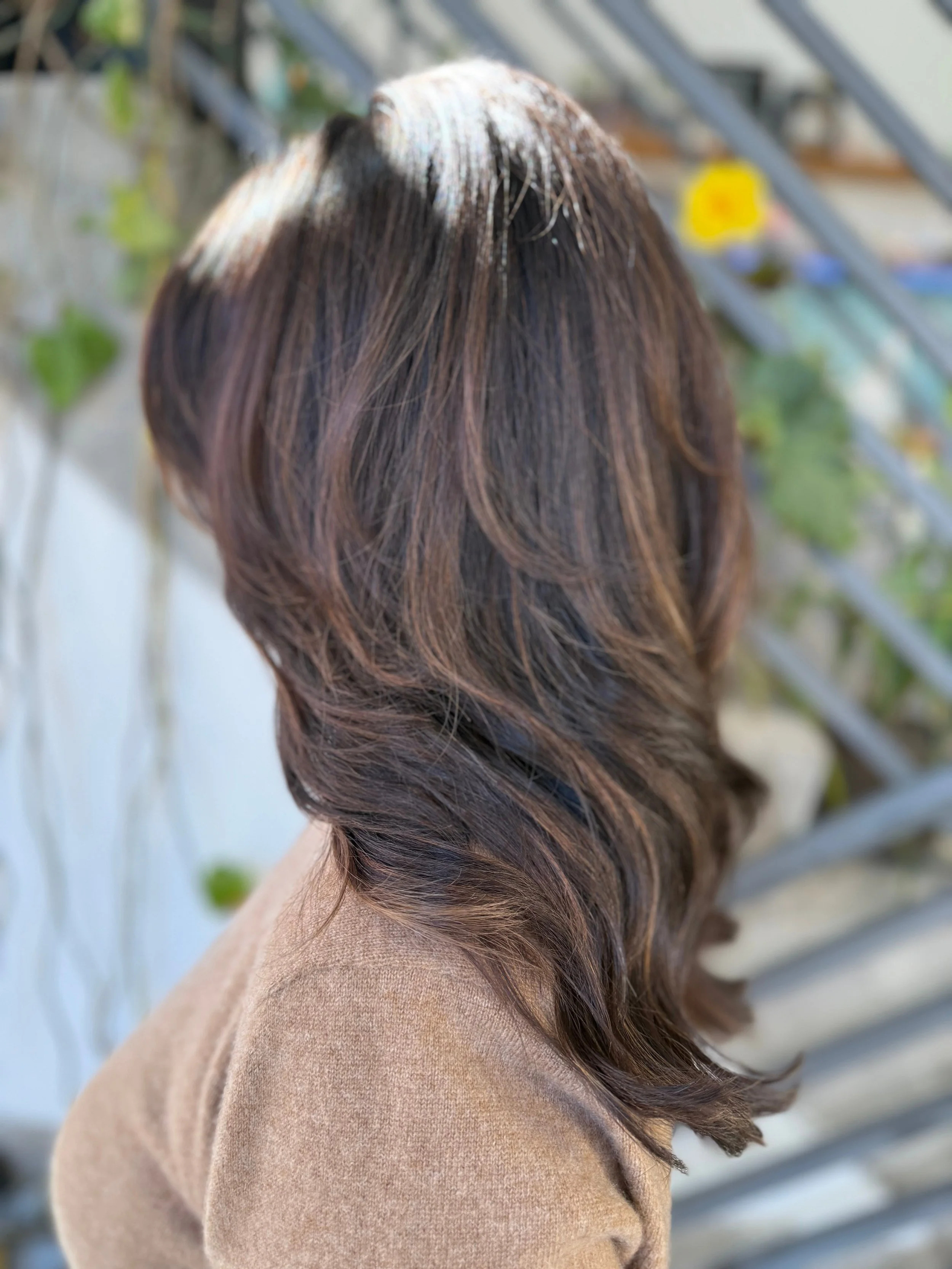 Candlelit brunette hair color with espresso, chestnut, and toffee tones by Gem House Salon in Greenpoint Brooklyn.