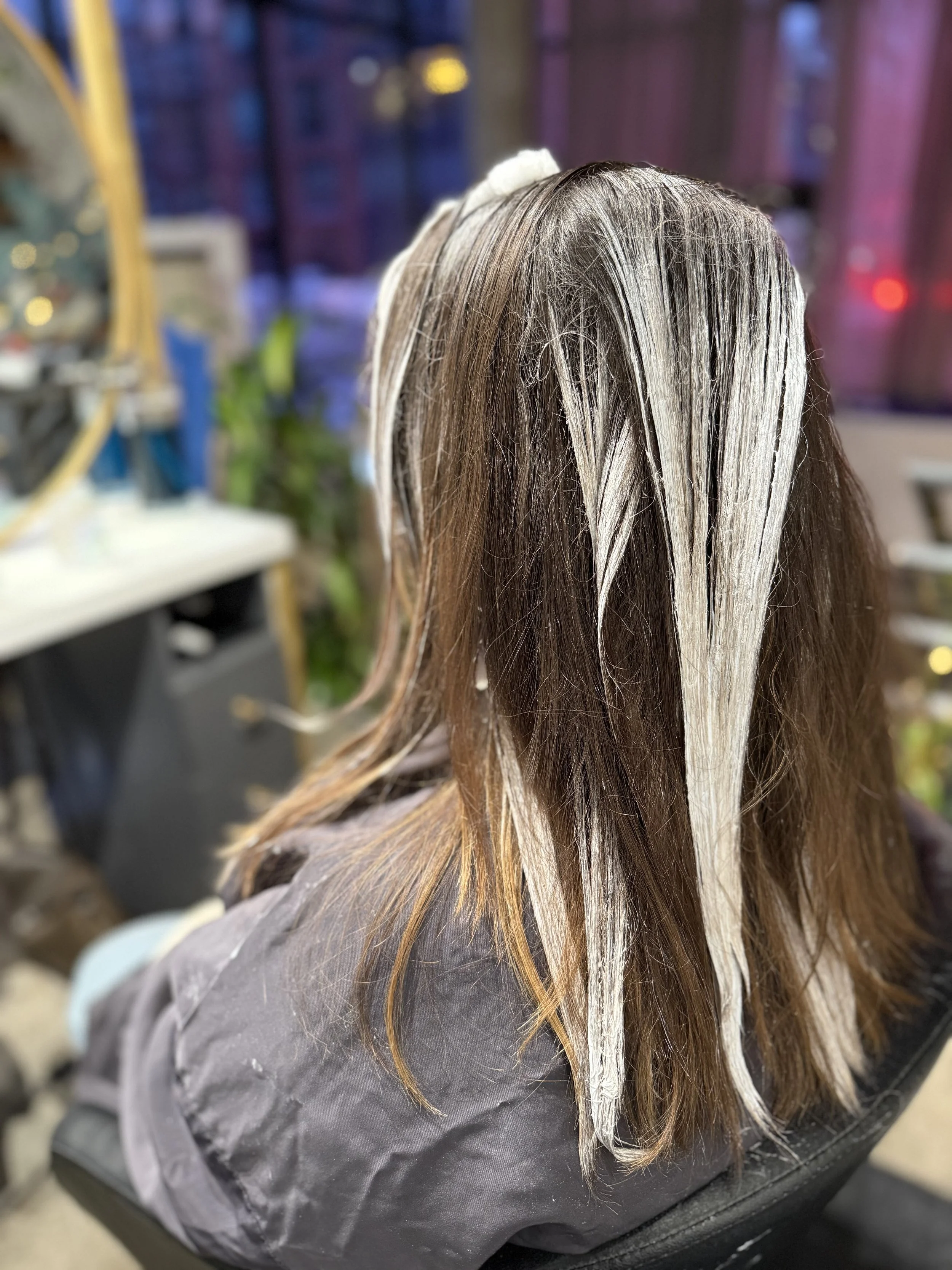 Balayage and lowlights processing for grey blending at a Greenpoint Brooklyn hair salon, creating soft, dimensional color.