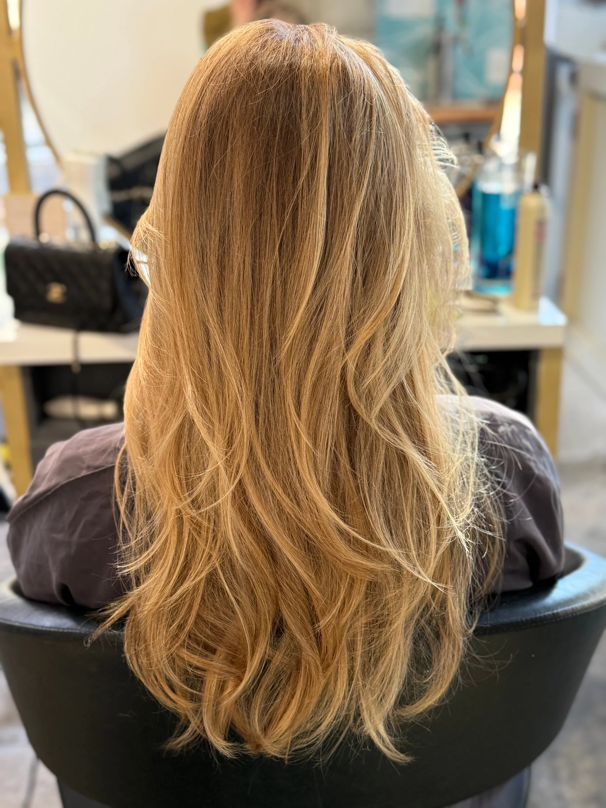Soft-focus blonde hair color with buttery champagne tones and root shadow by Gem House Salon in Greenpoint Brooklyn.