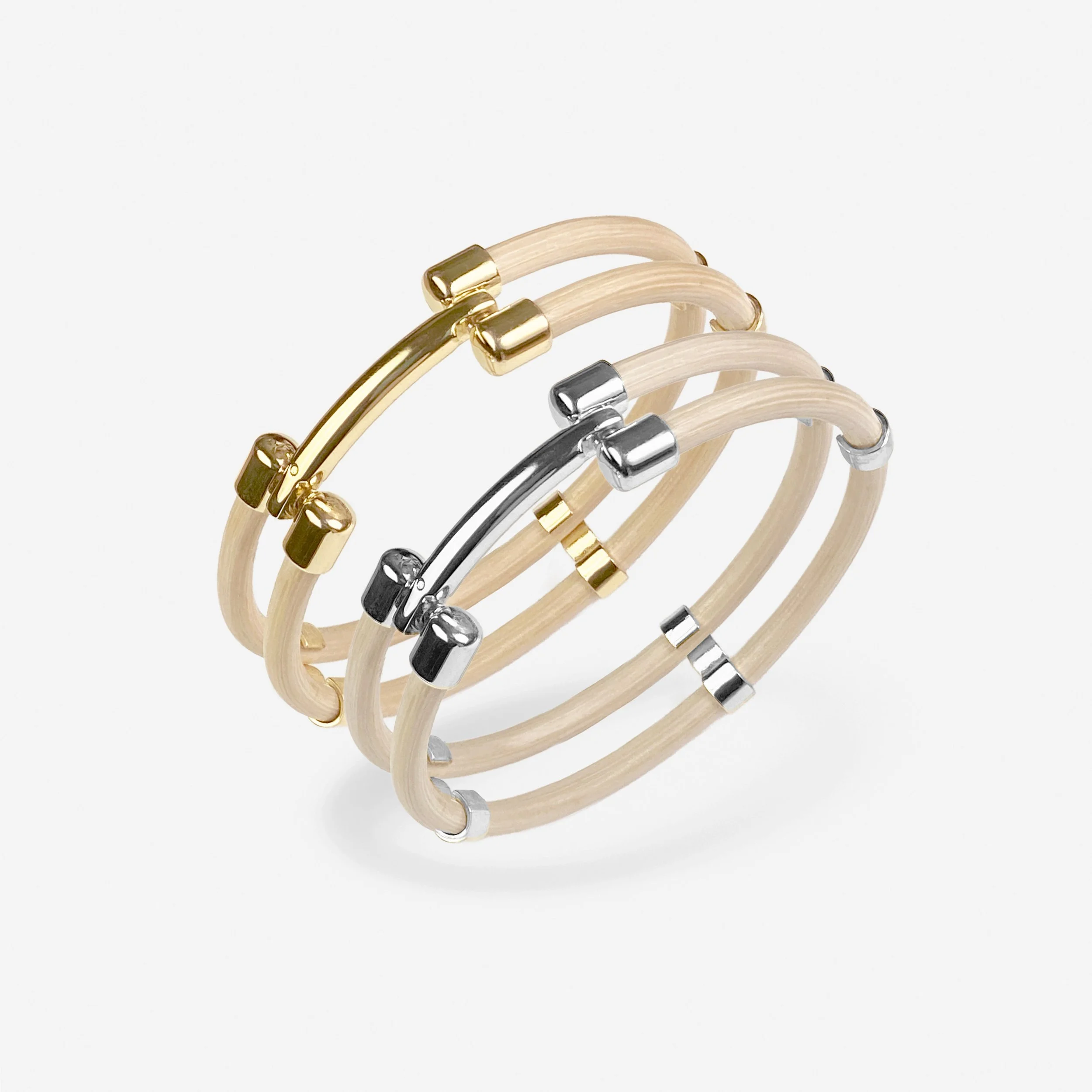 Les bracelets &agrave; double jonc en moelle de rotin naturelle couleur ivoire, sublim&eacute;s par une finition dor&eacute;e ou argent&eacute;e, sont prot&eacute;g&eacute;s et magnifi&eacute;s par une fine couche de vernis qui pr&eacute;serve et val