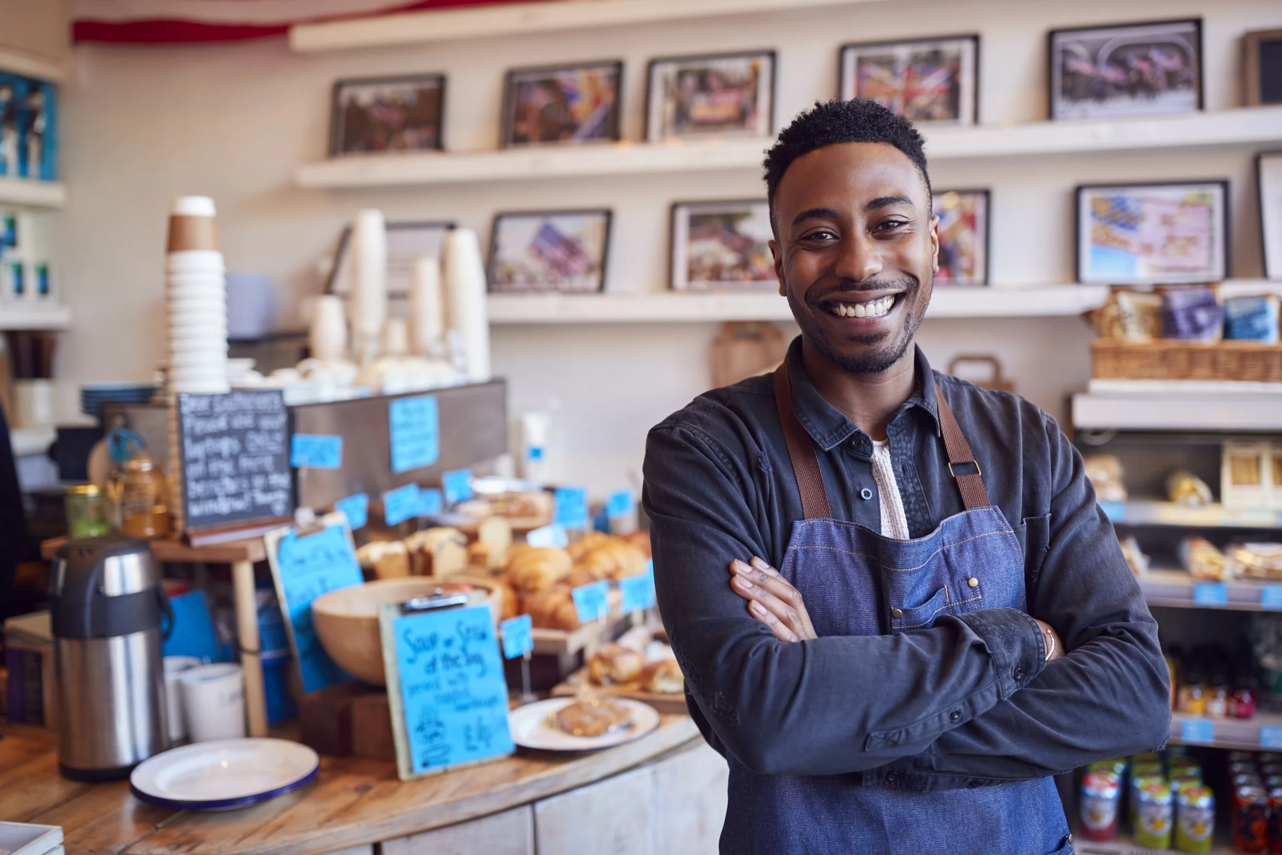 portrait-smiling-male-owner-coffee-shop-standing-by-counter.jpg