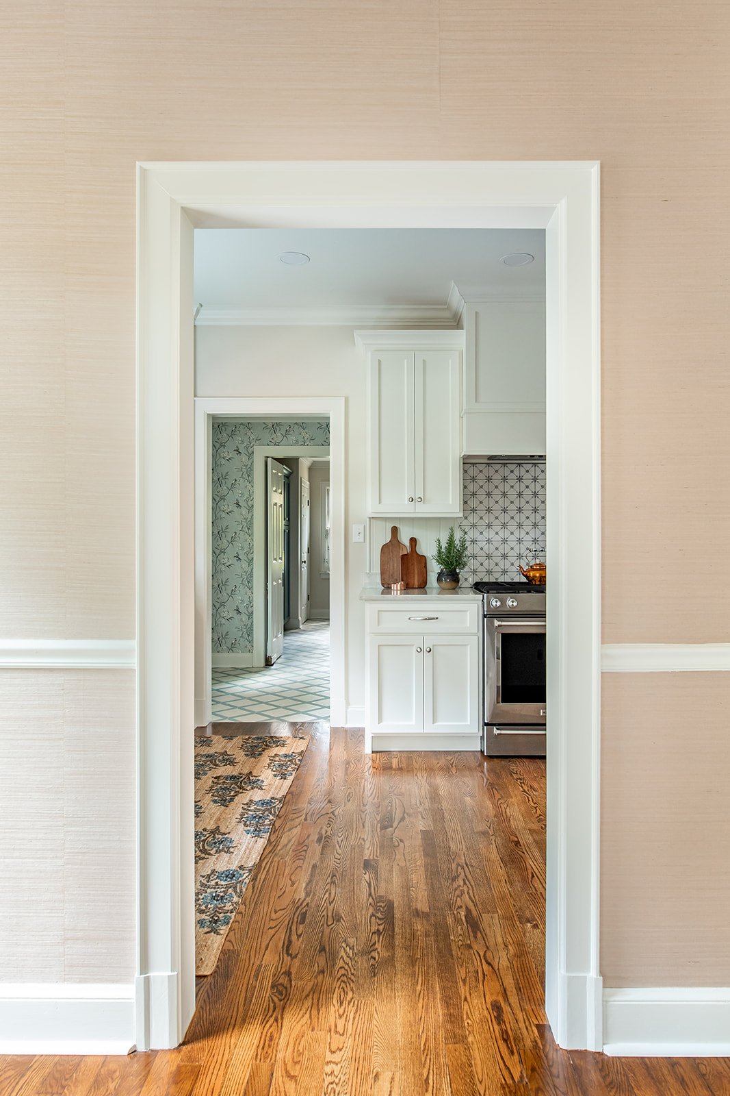 View from the grasscloth dining room into the kitchen and tiled back entry