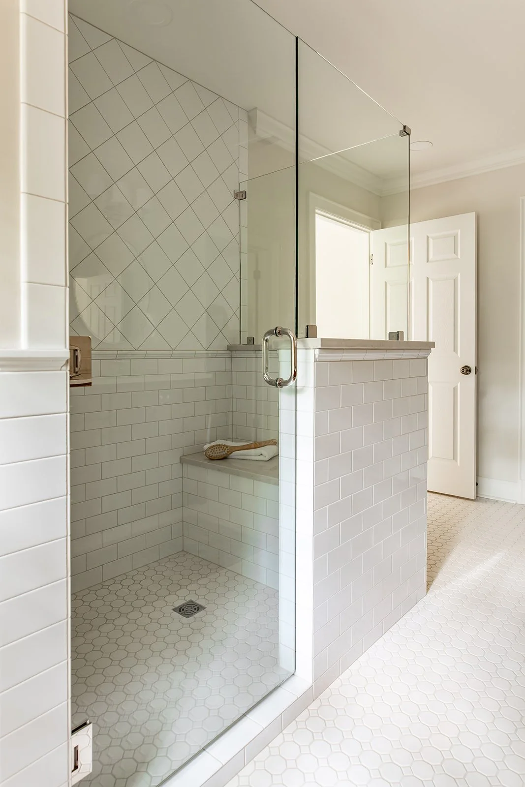 Inside the master shower with a bench, niche, with 6x6  diamond tile and subway tile
