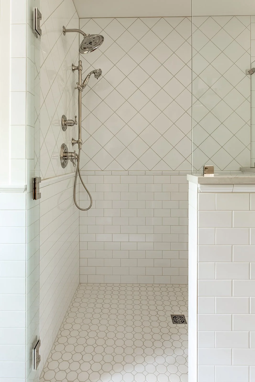 Master shower with diamond and subway tile and an octagon tile floor