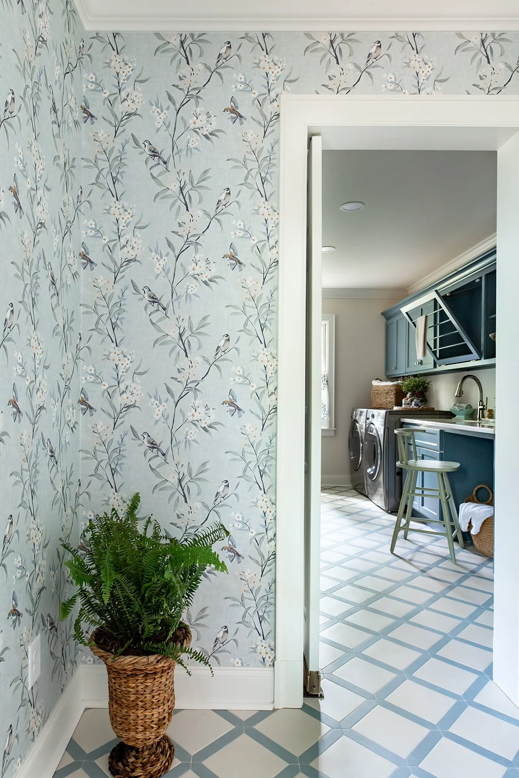 Light-filled side entry into a laundry room with checker board floors