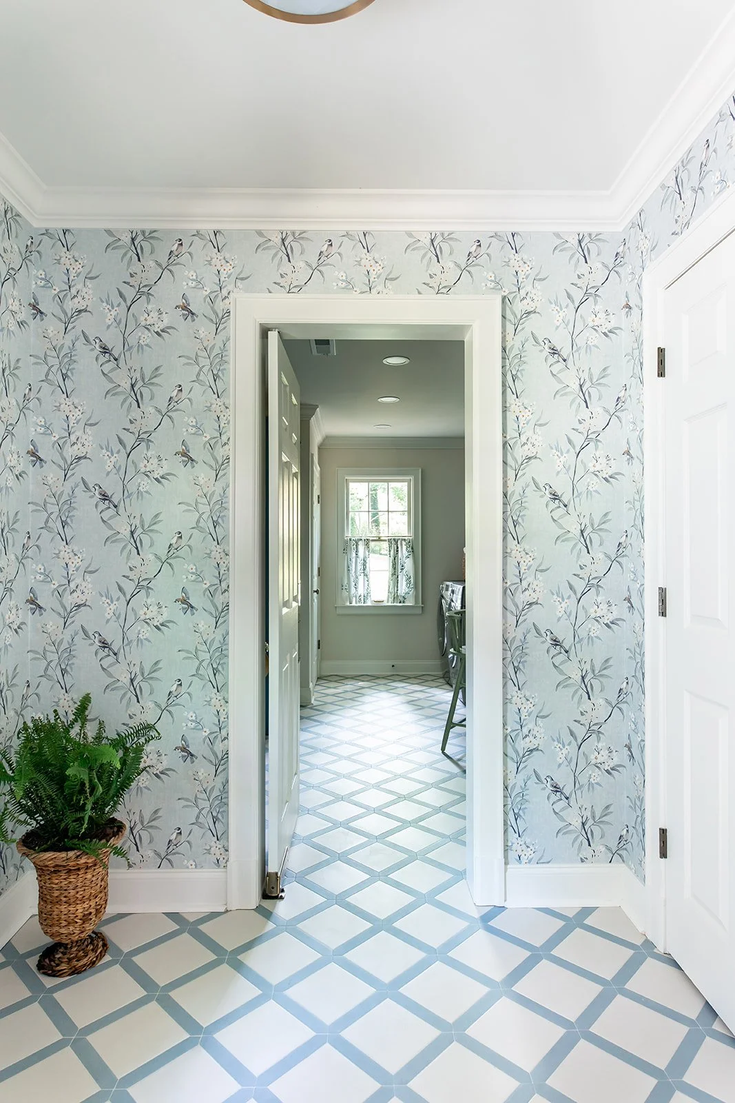 A side entry with blue chinoiserie wallpaper