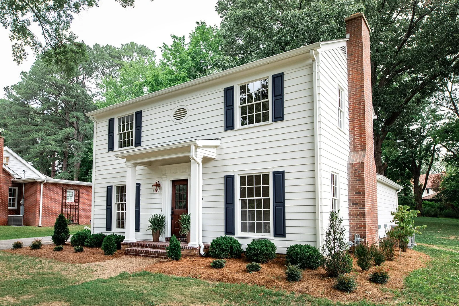 Curb view of the colonial's classic proportions and updated exterior