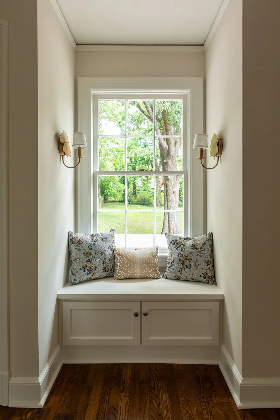 Sunny window-seat nook framed by original trim