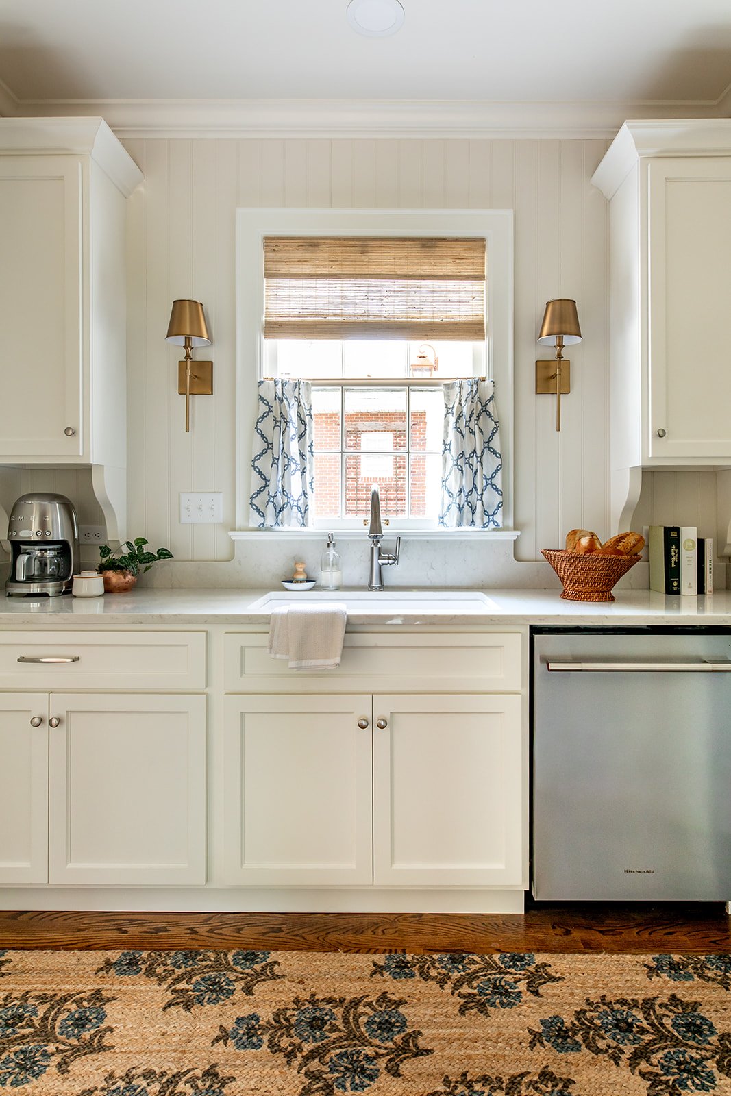 Bright remodeled white kitchen with custom cabinetry and new lighting