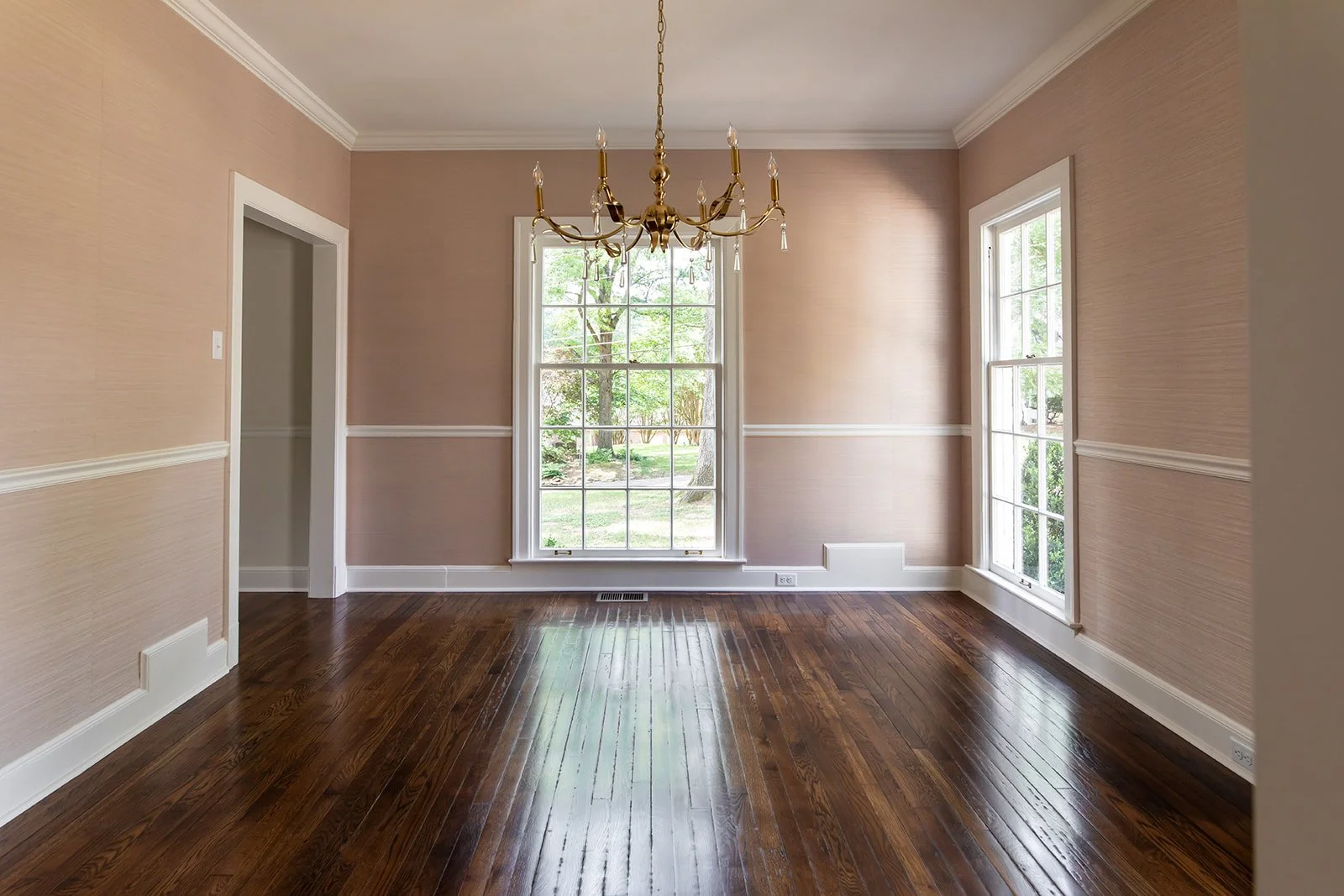 Dining room with detailed molding and restored hardwood floors
