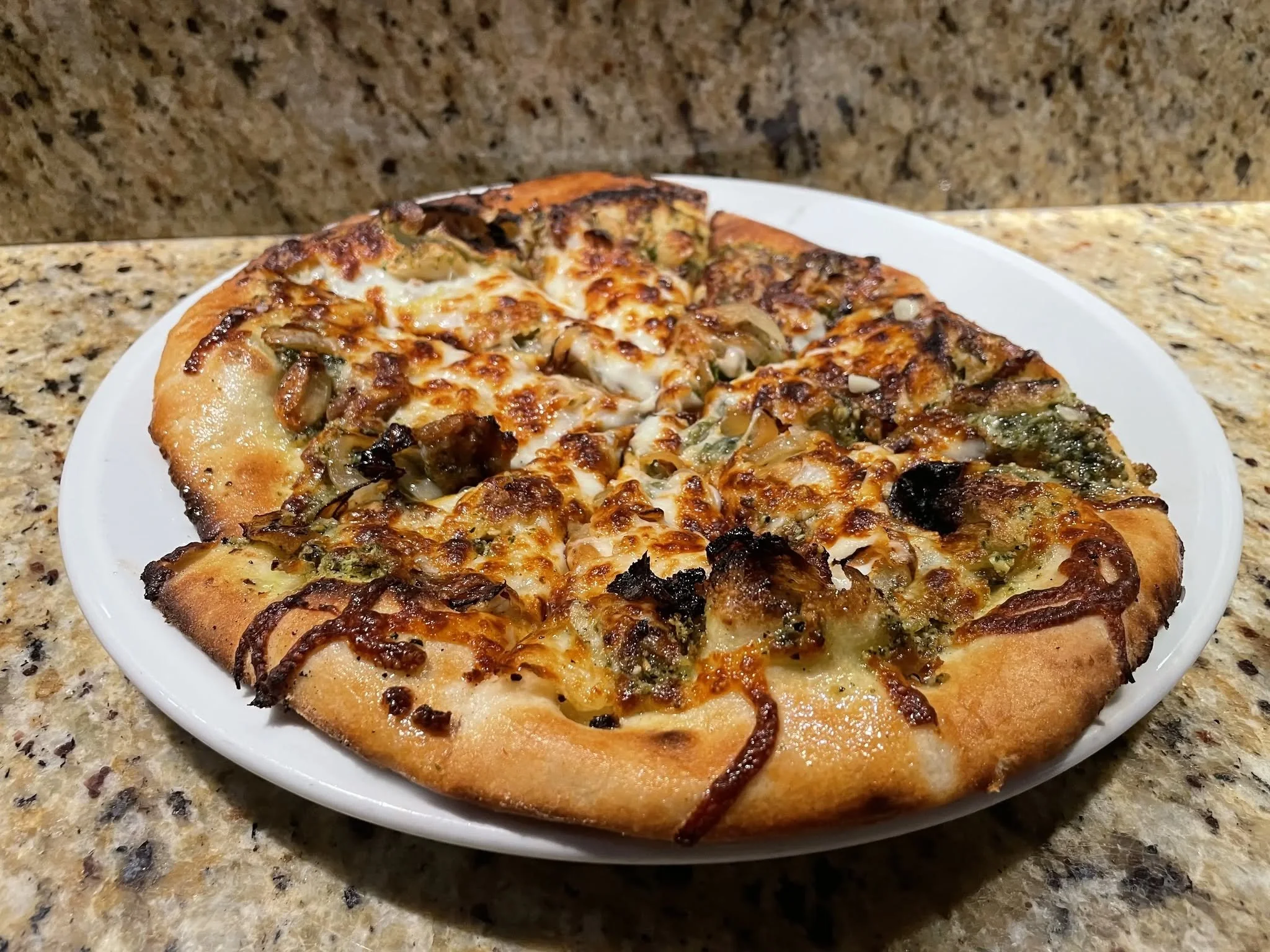 Sausage Pesto Pizza with basil pesto sauce, mozzarella, sausage, onion & garlic