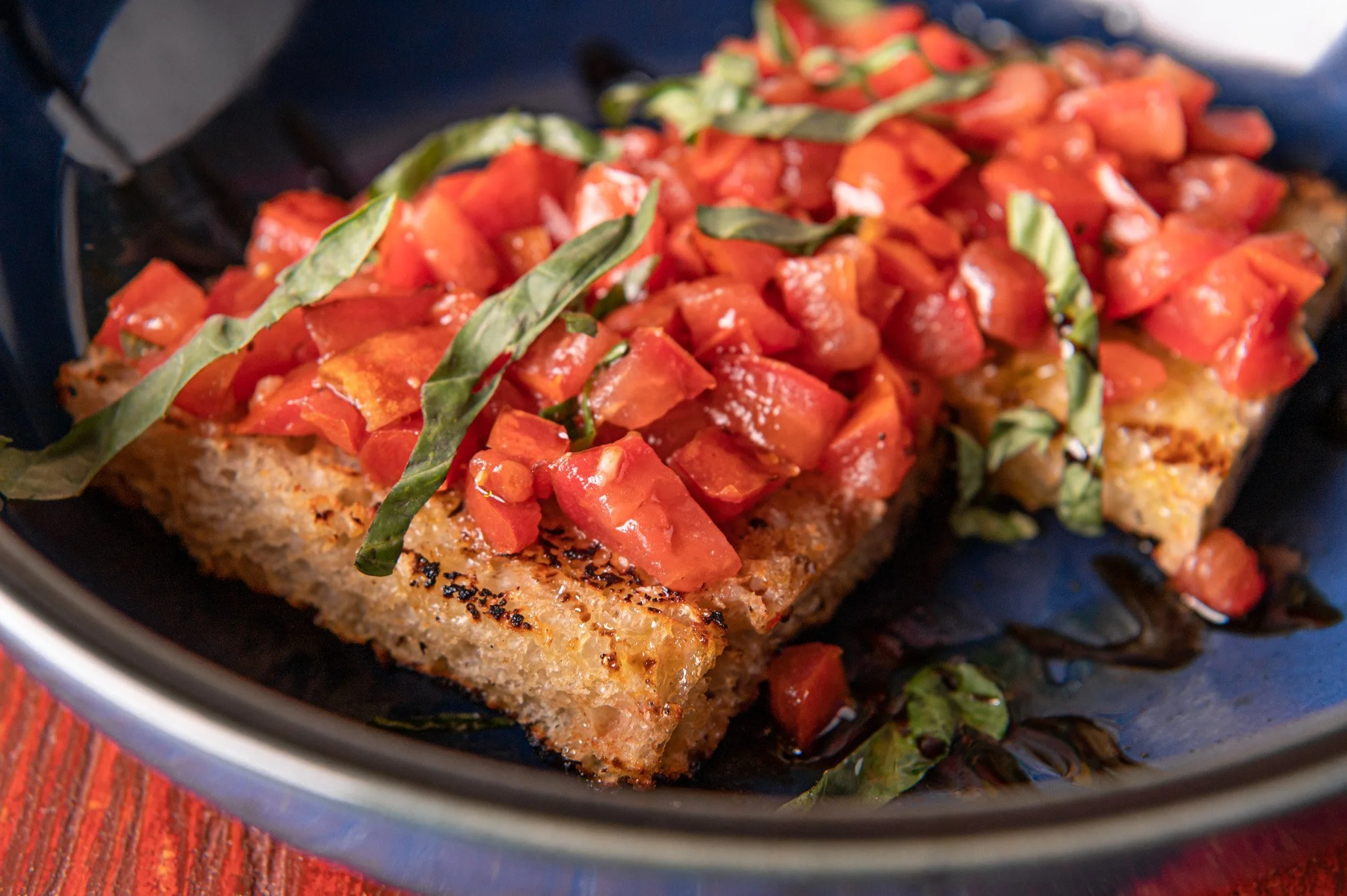 Bruschetta: toasted focaccia, marinated diced tomatoes, olive oil, balsamic glaze & fresh basil