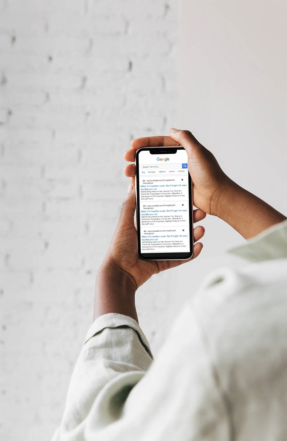 Woman holding an iPhone with the display in focus, showing a Google ad in the search results, highlighting the phone's screen in a dynamic shot.