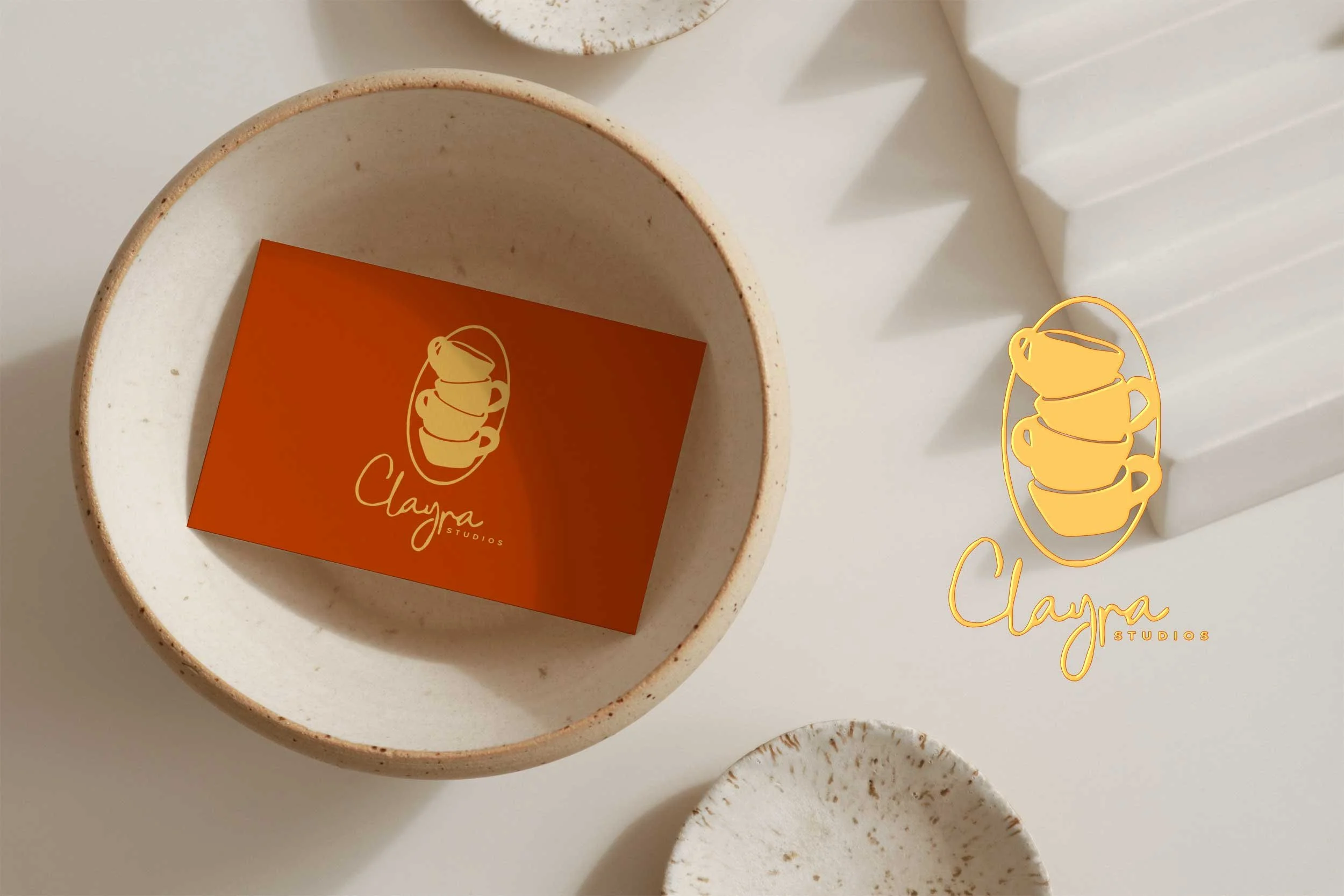 Custom business card placed on a table inside a wooden bowl, captured in a flat lay, with a clean and minimalist design enhancing the brand’s identity.