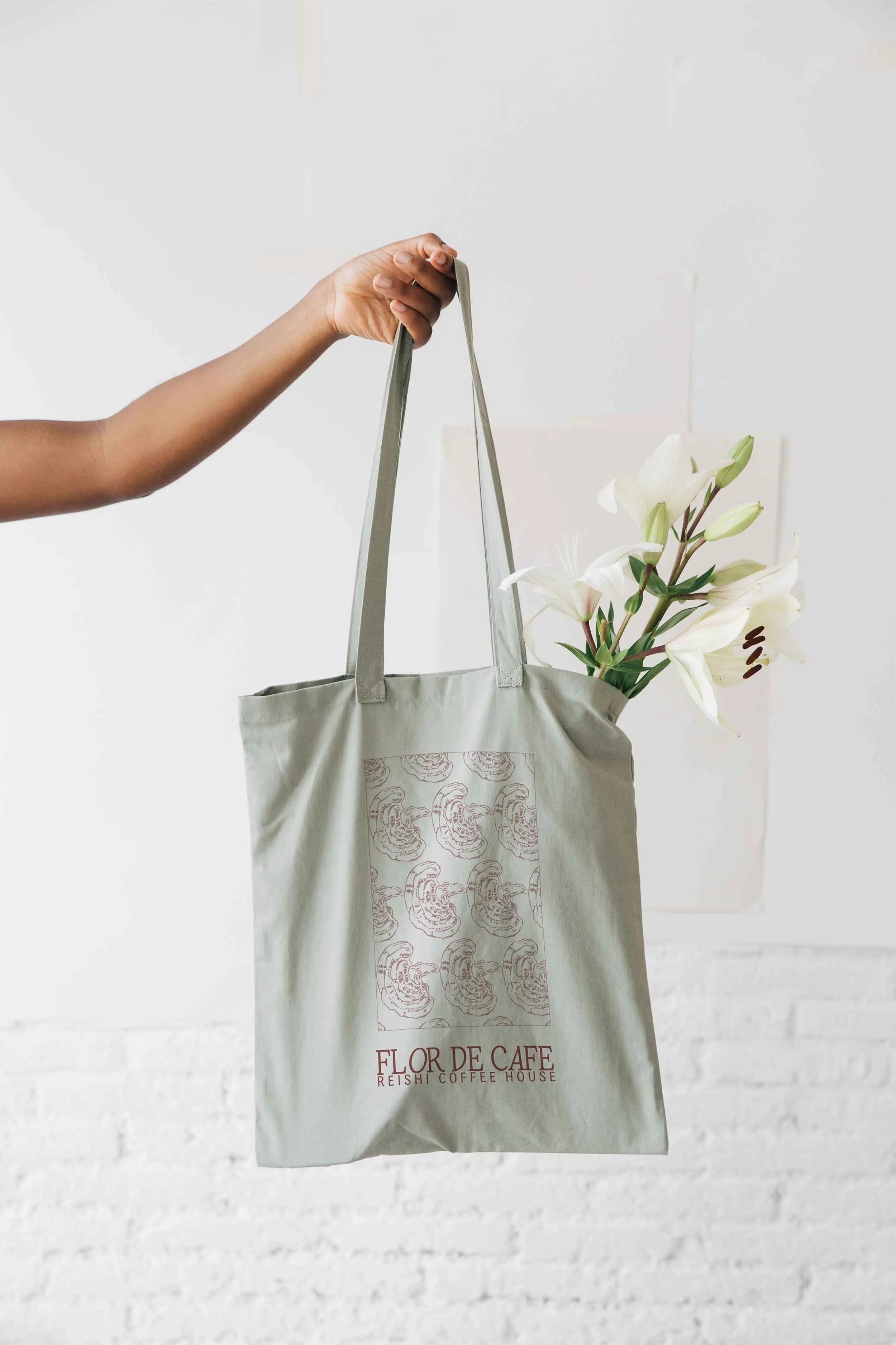 arm is holding bag with custom brand pattern created for an artisan cafe. Visual Brand Identity created by Neourish Brand Marketing Studio.