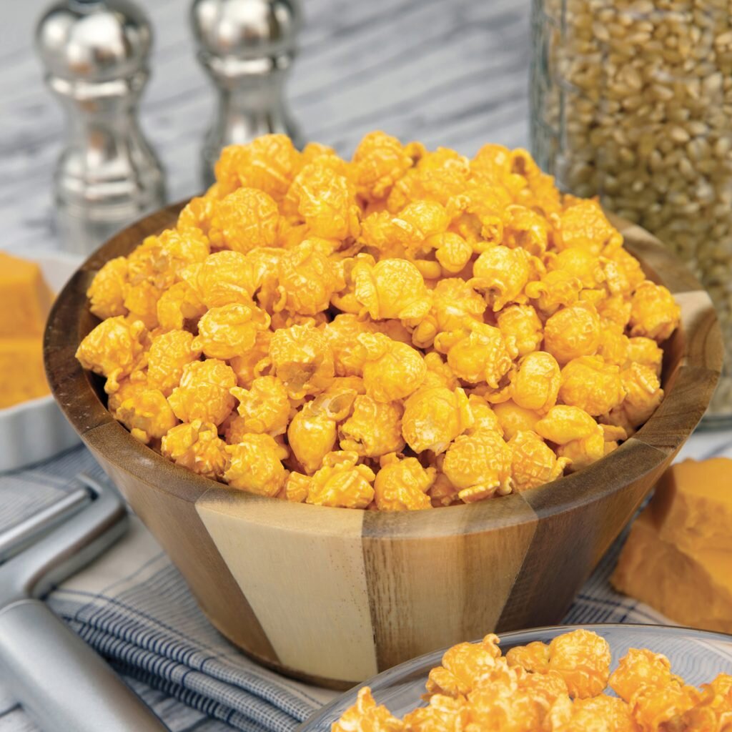 CHEESY CHEDDAR-
Our signature blend of kernels, mixed with our secret blend of gourmet cheeses provides the most delicious cheesy cheddar corn ever! A must try! Gluten Free.