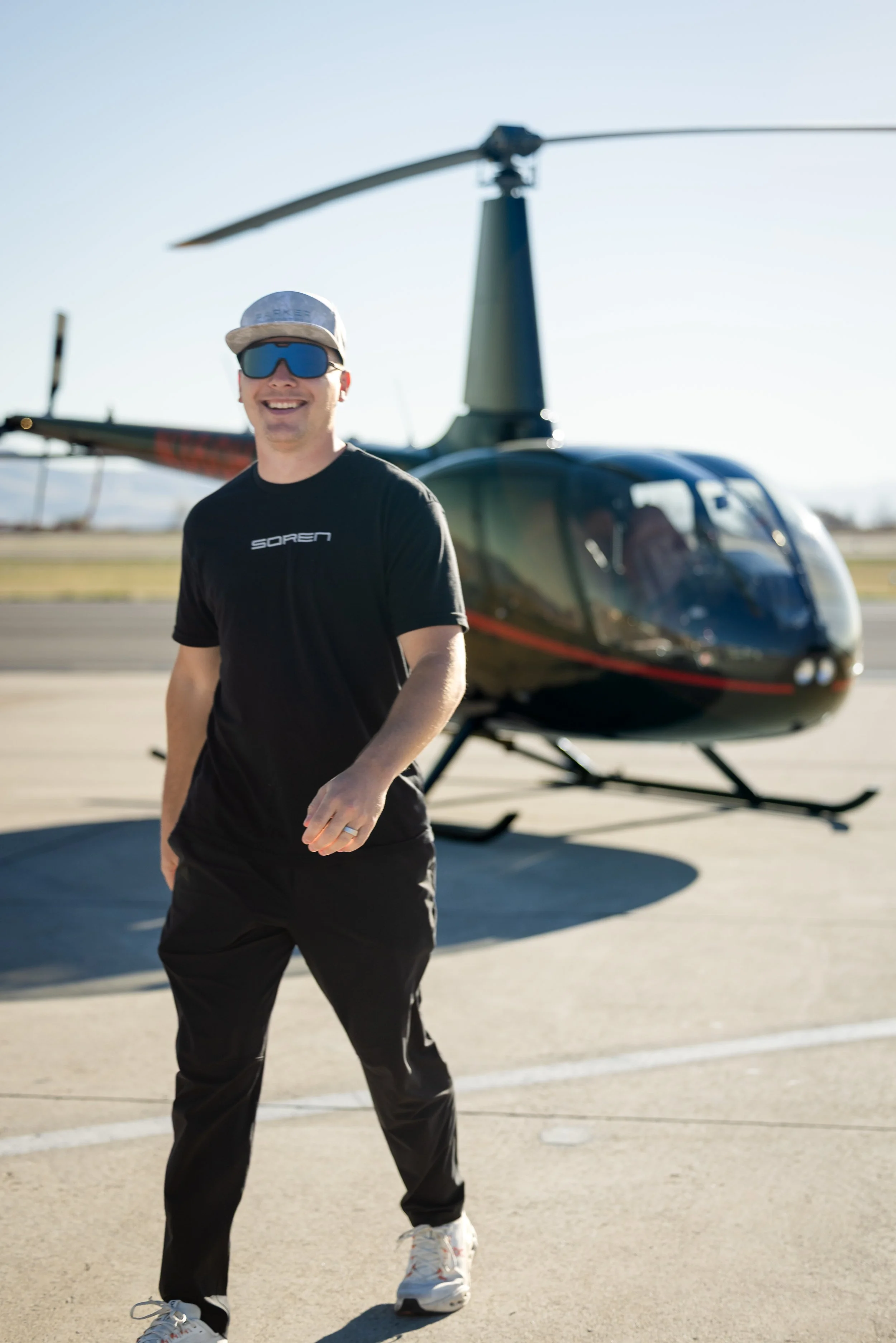 Helicopter pilot walkin by Robinson R66