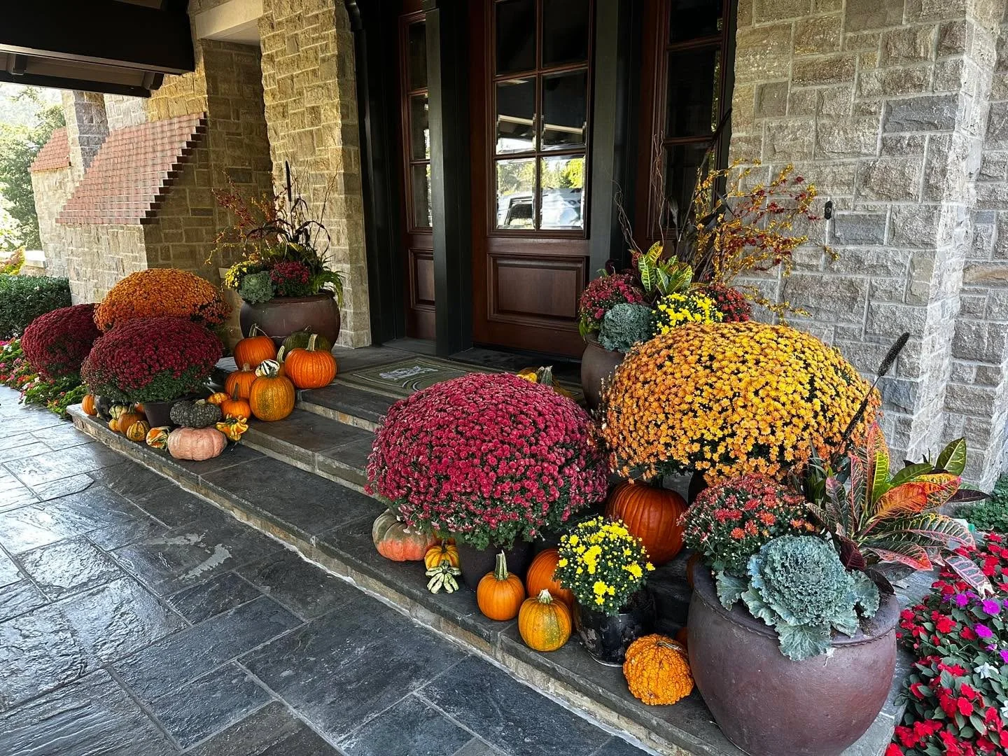 Fall is here!  Outdoor Environments  maintenance team is making this front door area look beautiful! #landscapemanagement #landscapemaintenance #fallvibes #falldecor #fallseason