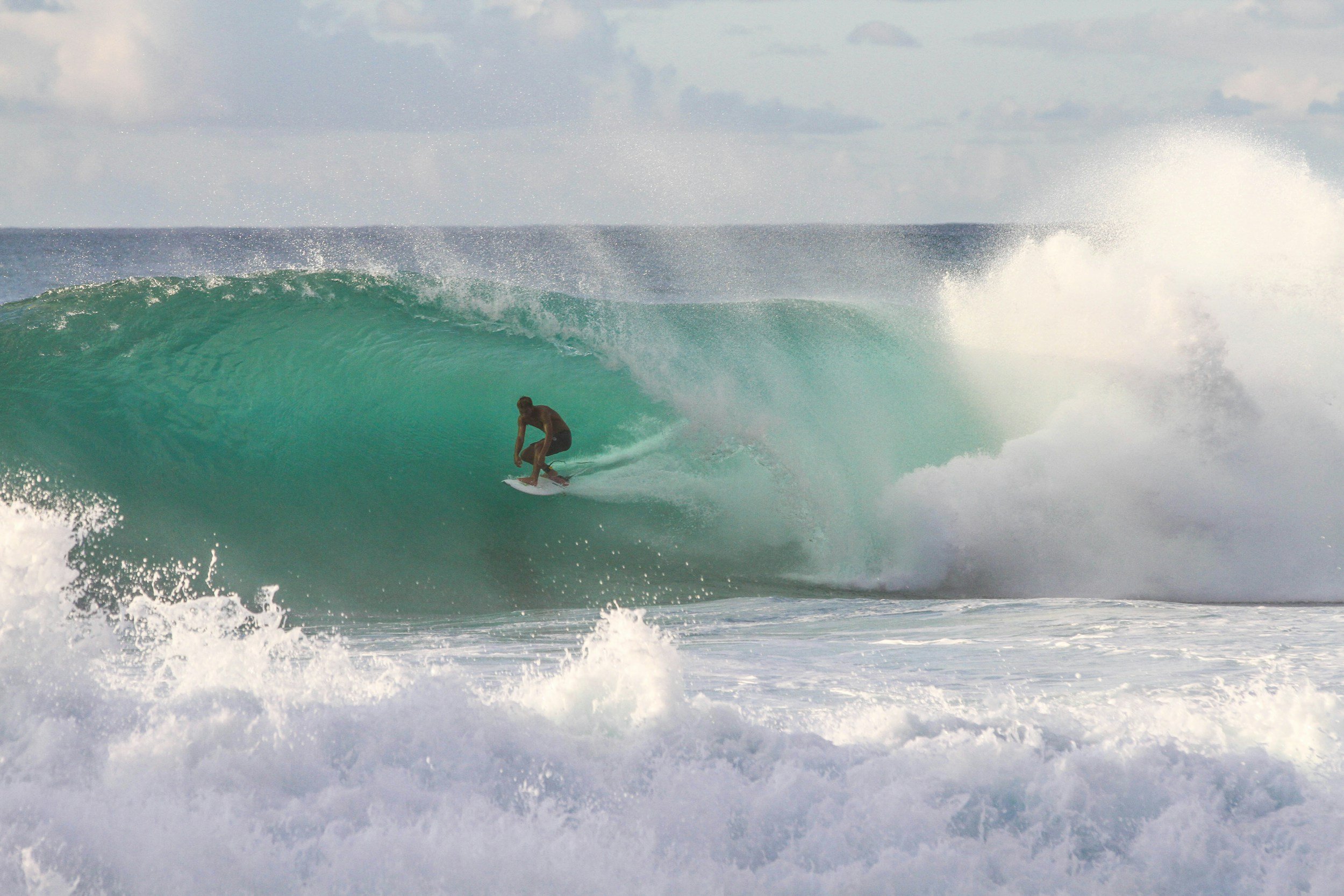 Surfer doing thoracic mobility exercise for lower back pain rehab