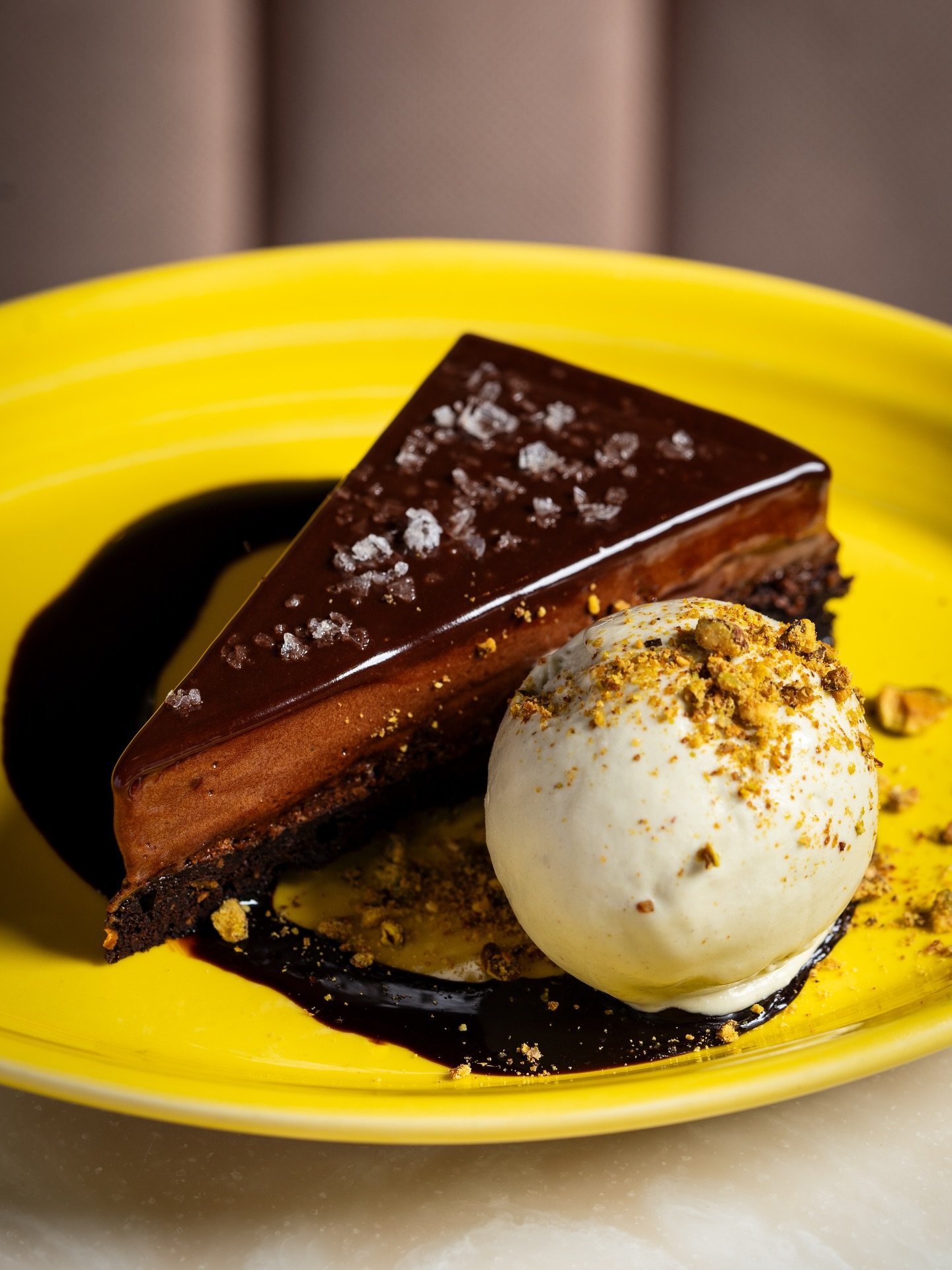 Chocolate Mousse Pie with candied pistachios, brownie, chocolate syrup, and pistachio ice cream.