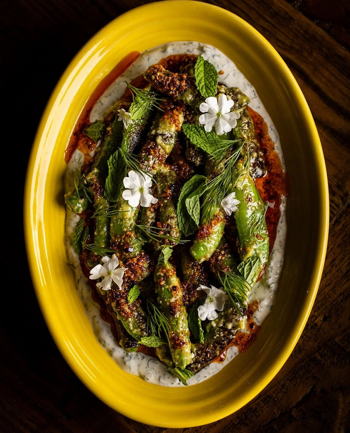 Back for the season. Snap peas from @theeecologycenter, lightly charred, set over dill labneh with chili crunch, pistachio, almond, and green garlic. Simple, bright, and exactly what we want to be eating right now.