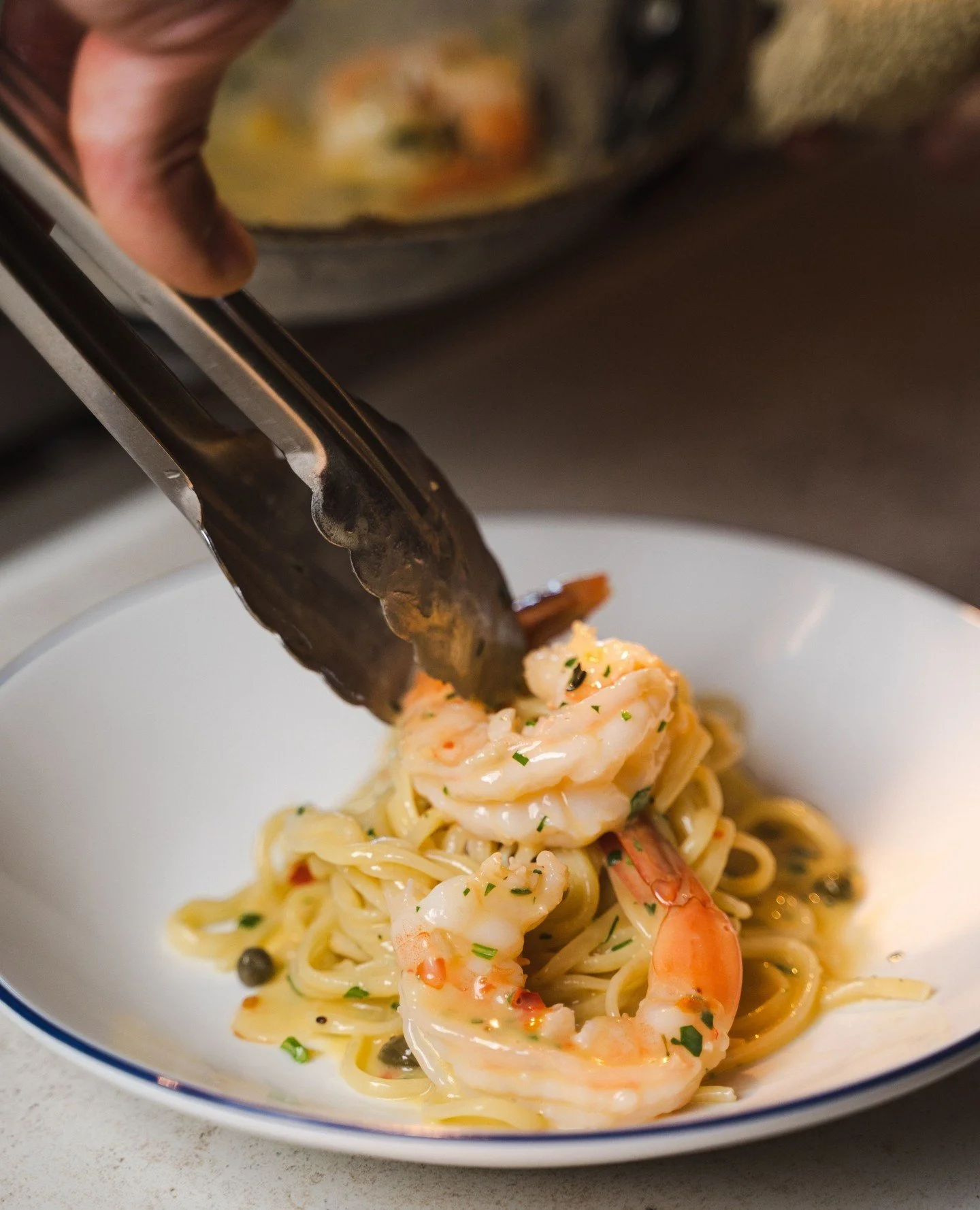 ORDER UP. Shrimp Linguini with preserved lemon, capers, parsley, and calabrian chili.