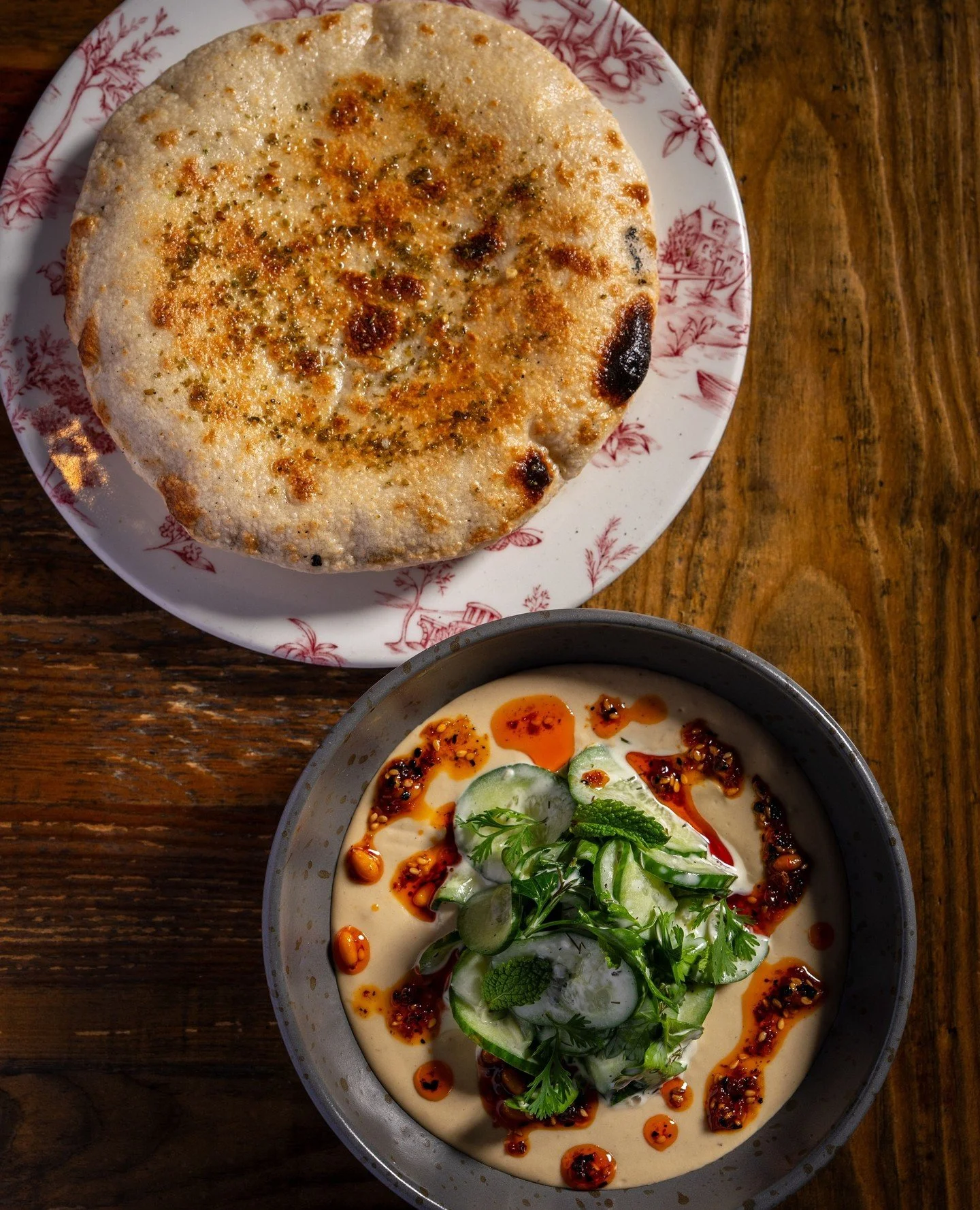 Pita &amp; Pickles. We char the eggplant until it's smoky, then blend it silky. The real move happens on top: house-made pickles and relish from produce grown at Sage Hill Gardens.⁠
⁠
It comes out alongside pita made in-house and warmed to order in t