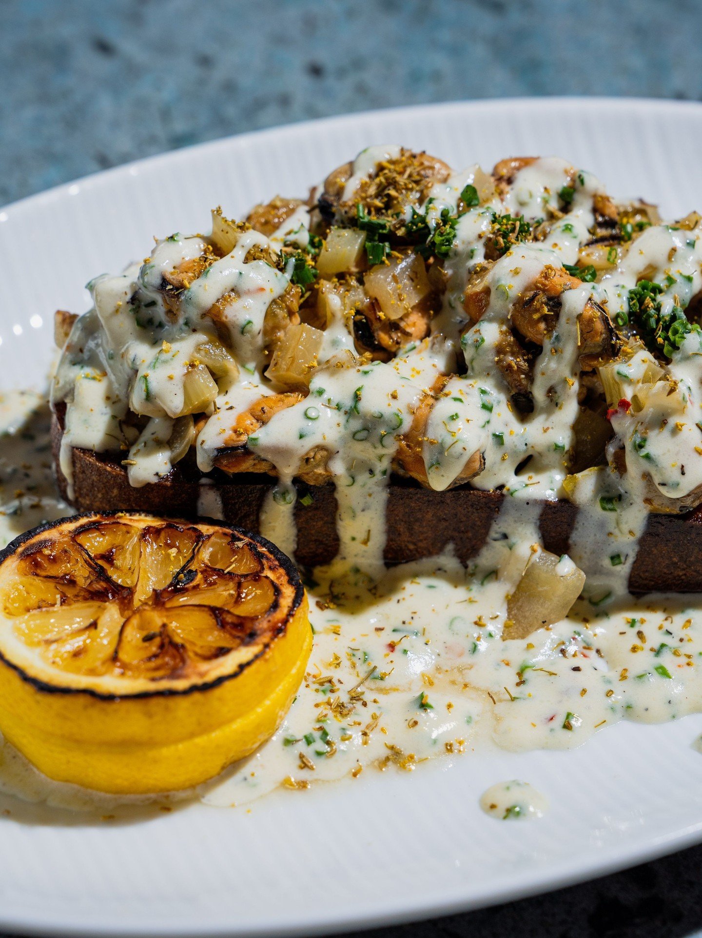One of those appetizers that tends to become the table&rsquo;s favorite. Mussels, brie, fennel and onion over sourdough, finished with white wine butter sauce.