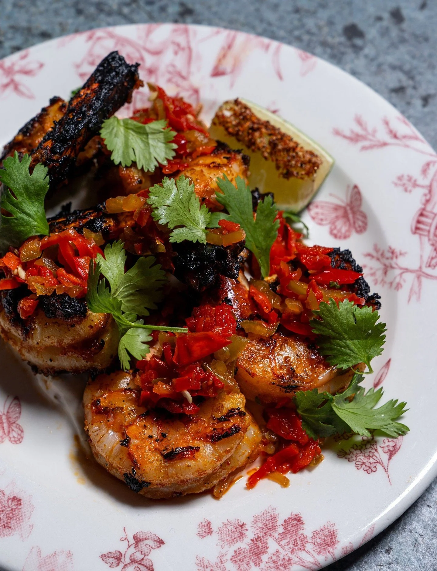 The kind of shrimp that calls for an extra squeeze of lime. Spicy Baja Shrimp with smoked jalape&ntilde;o yogurt, pickled pepperonata, lime, and taj&iacute;n.