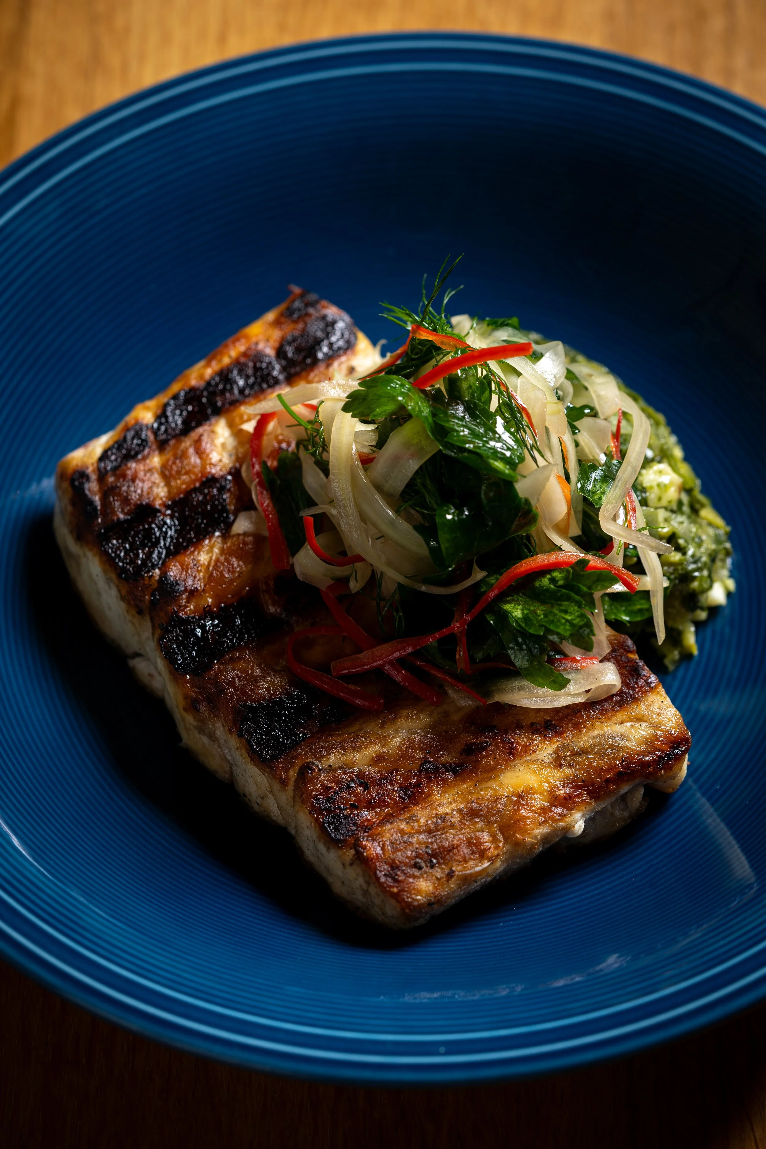 Seared local swordfish with tomato piccata, heirloom tomato, mustard frill
