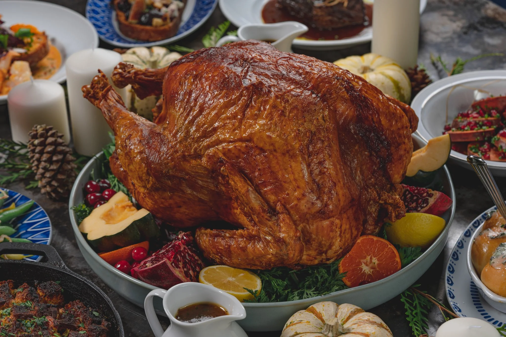 Roasted Turkey dressed on a blue platter for Thanksgiving