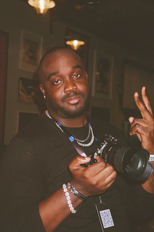 SJ Montana, videographer and creative director, holding his camera