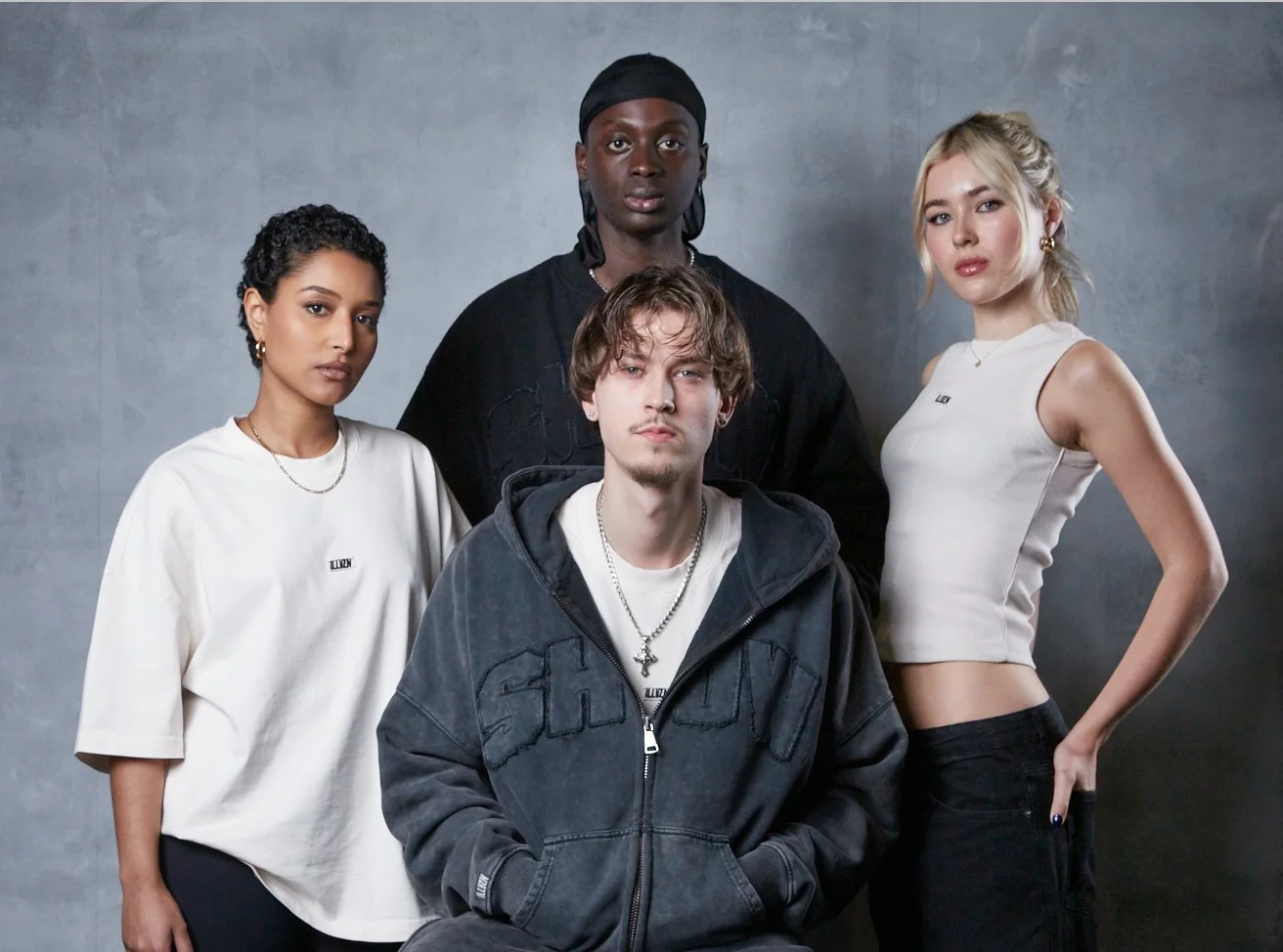 Four creators posing together in the studio