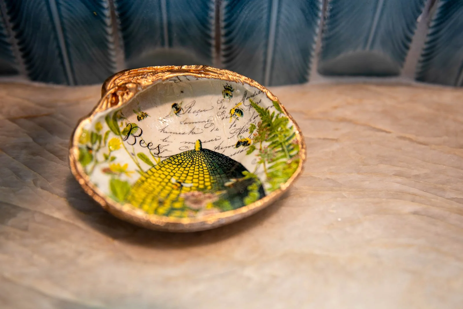 Decorative ceramic bowl with bees and sunflower design, placed on a wooden surface.